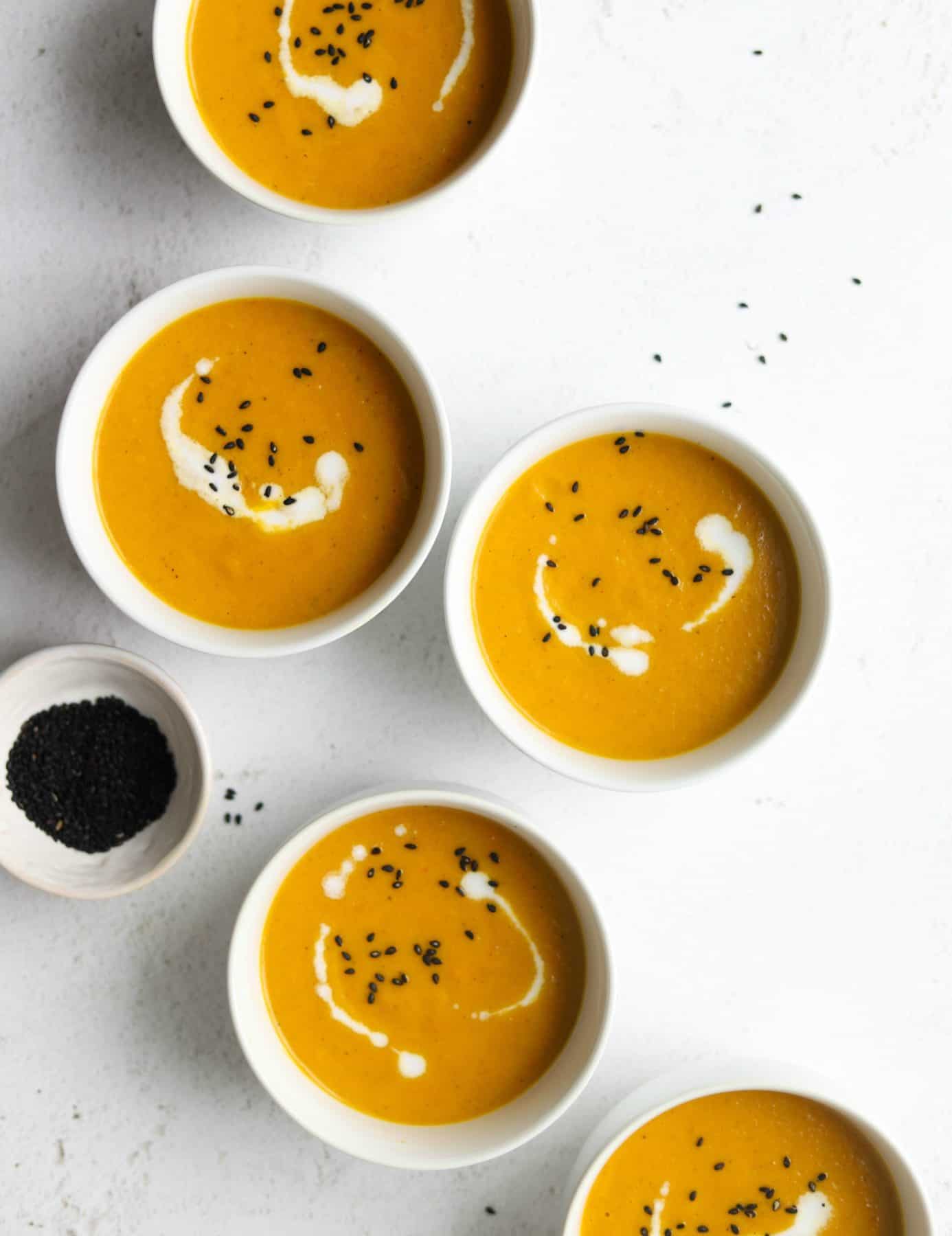 Carrot soup in white bowls