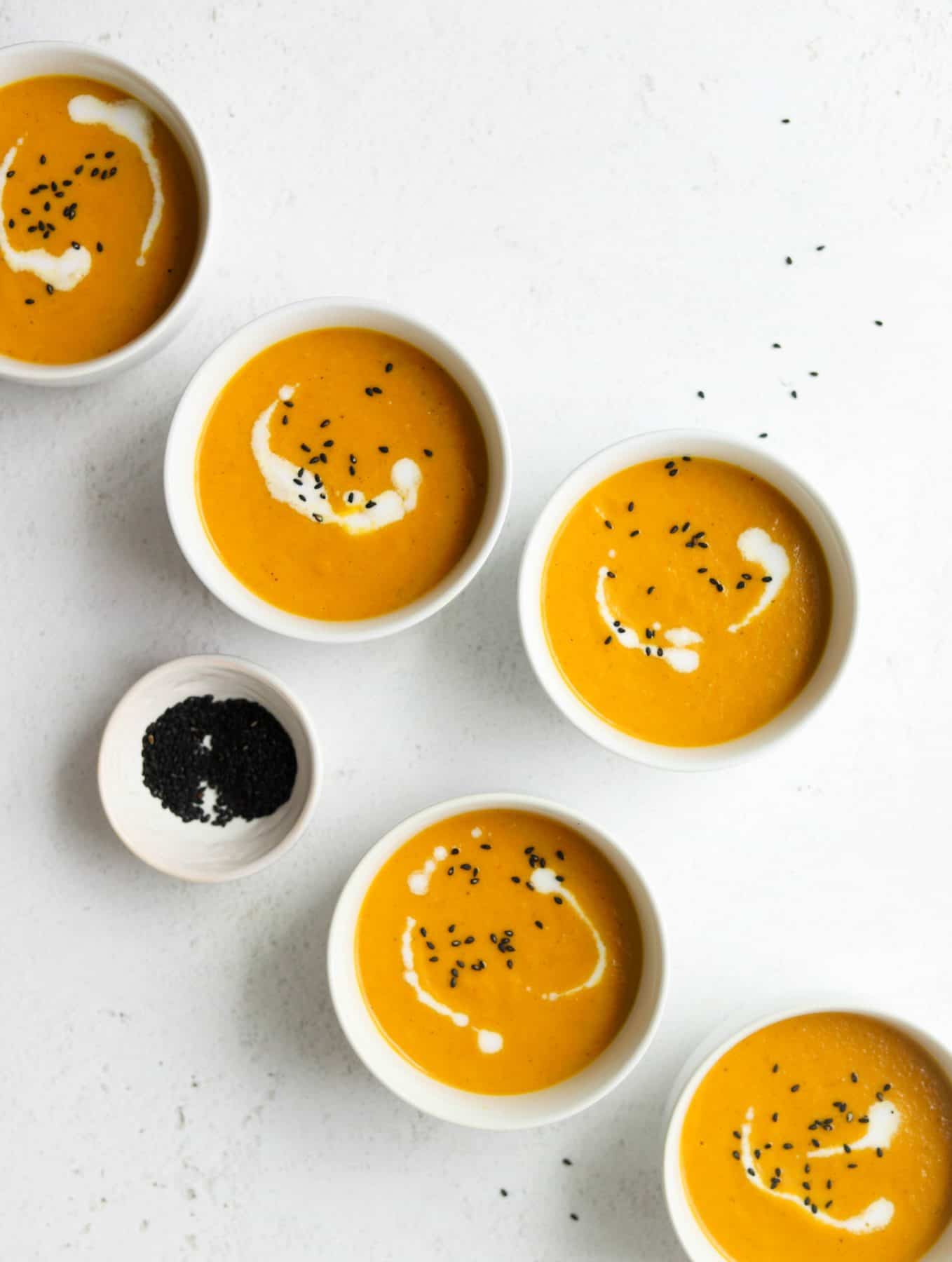 Carrot ginger soup in white bowls