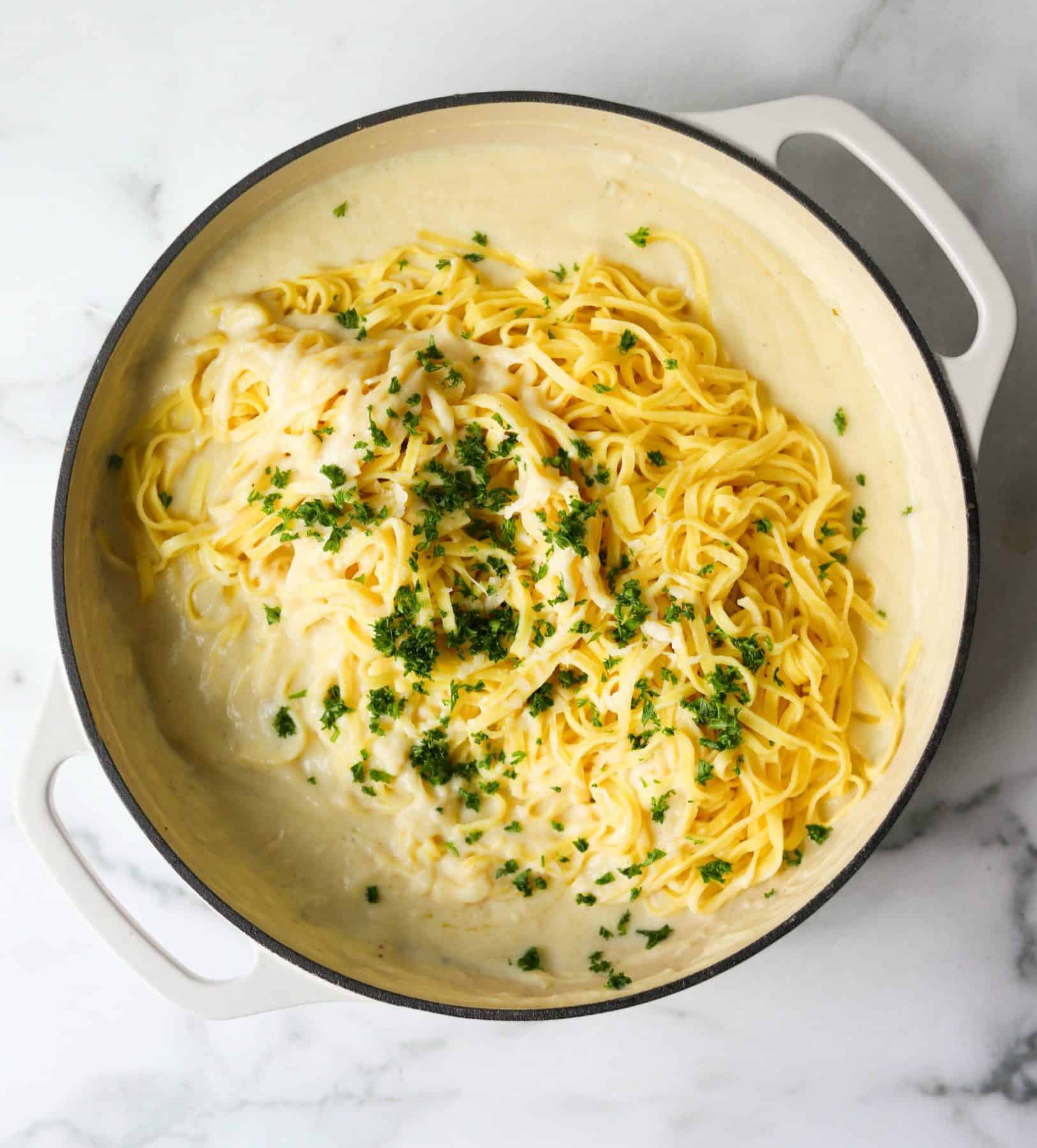 Cauliflower alfredo sauce in white pot