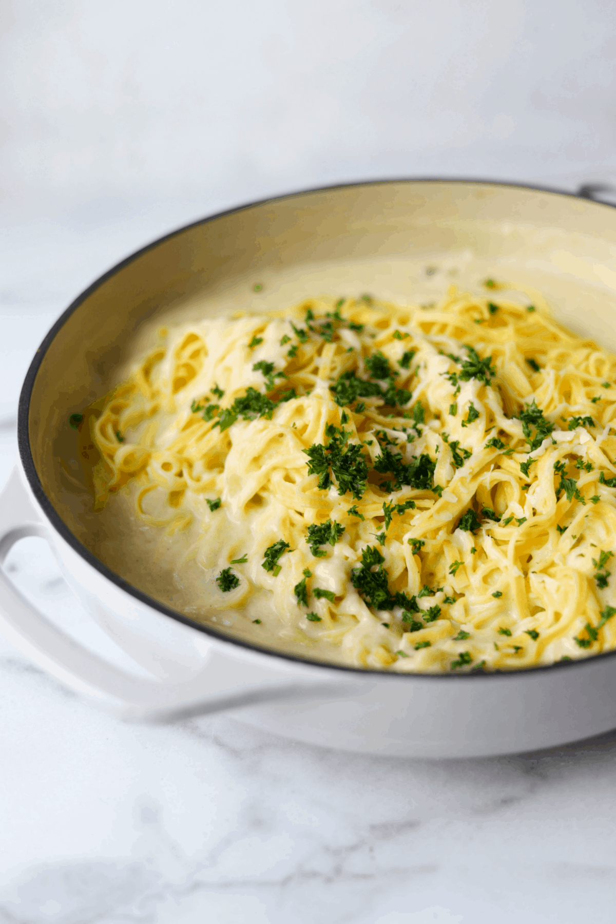 Cauliflower alfredo sauce in white pot