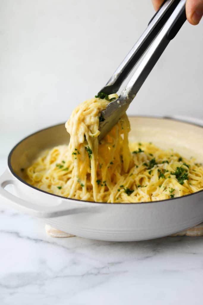 Cauliflower alfredo sauce in white pot