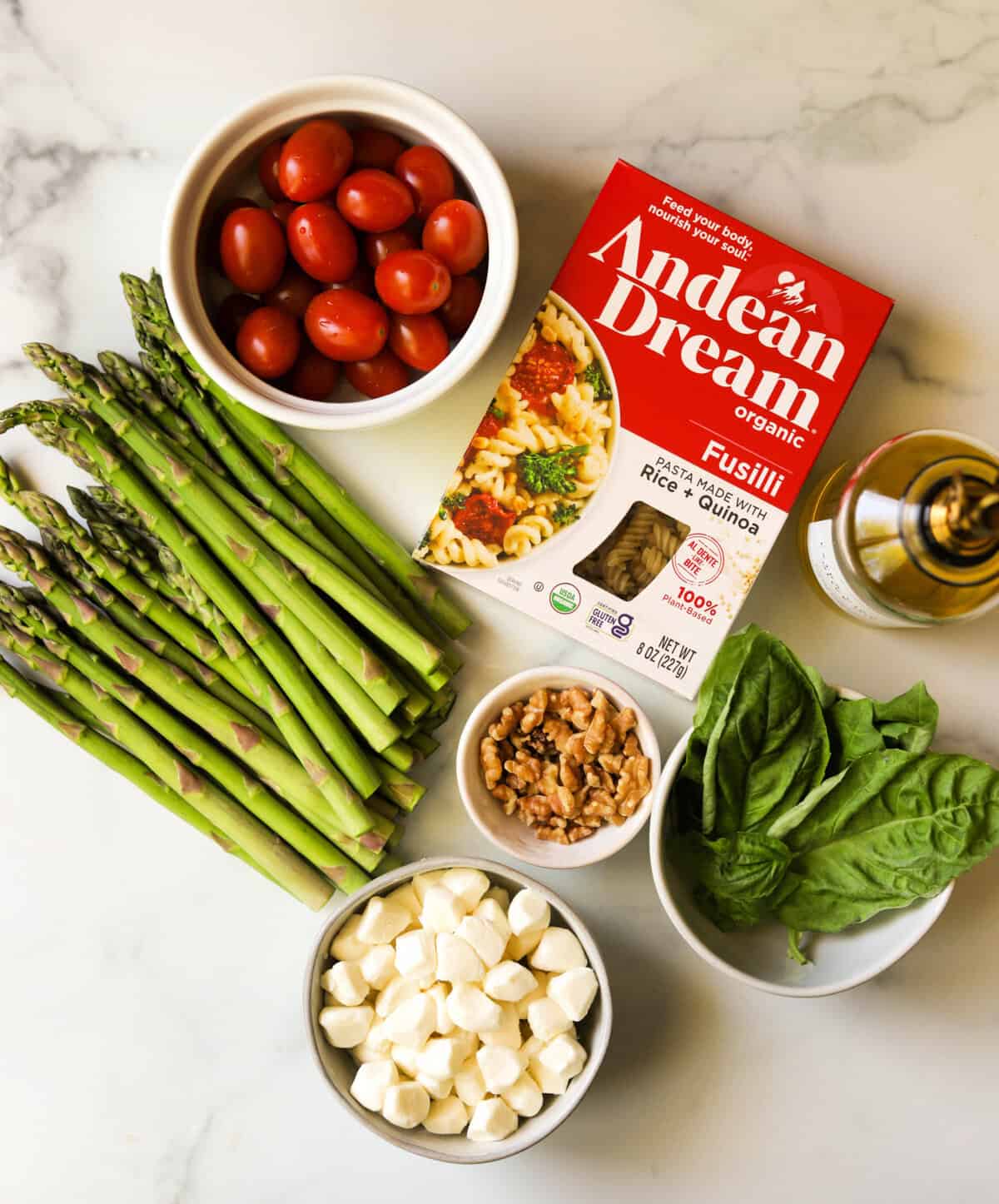 An overhead shot of ingredients to make asparagus pesto pasta salad.