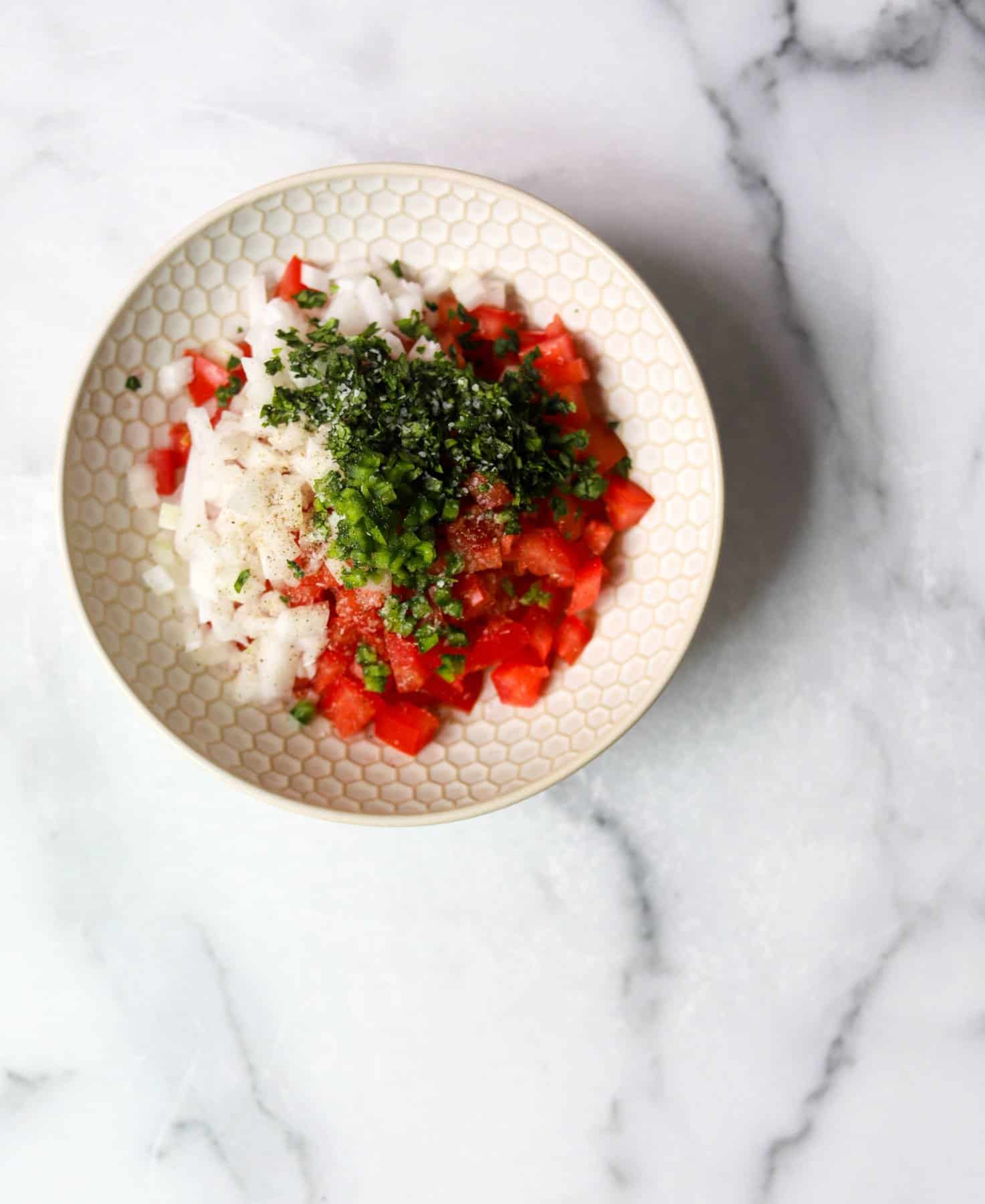 Pico de gallo in a white bowl