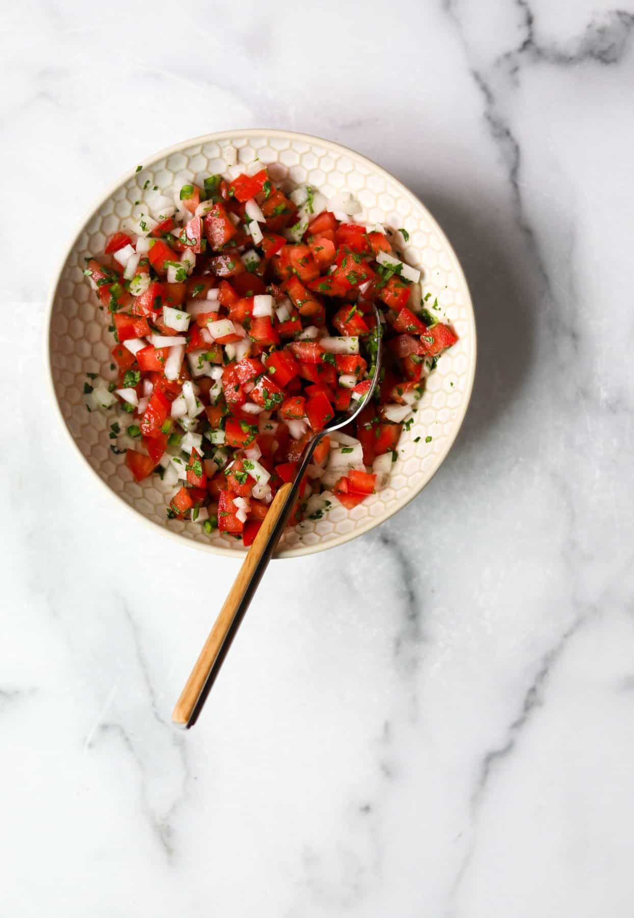 Pico de gallo in a white bowl