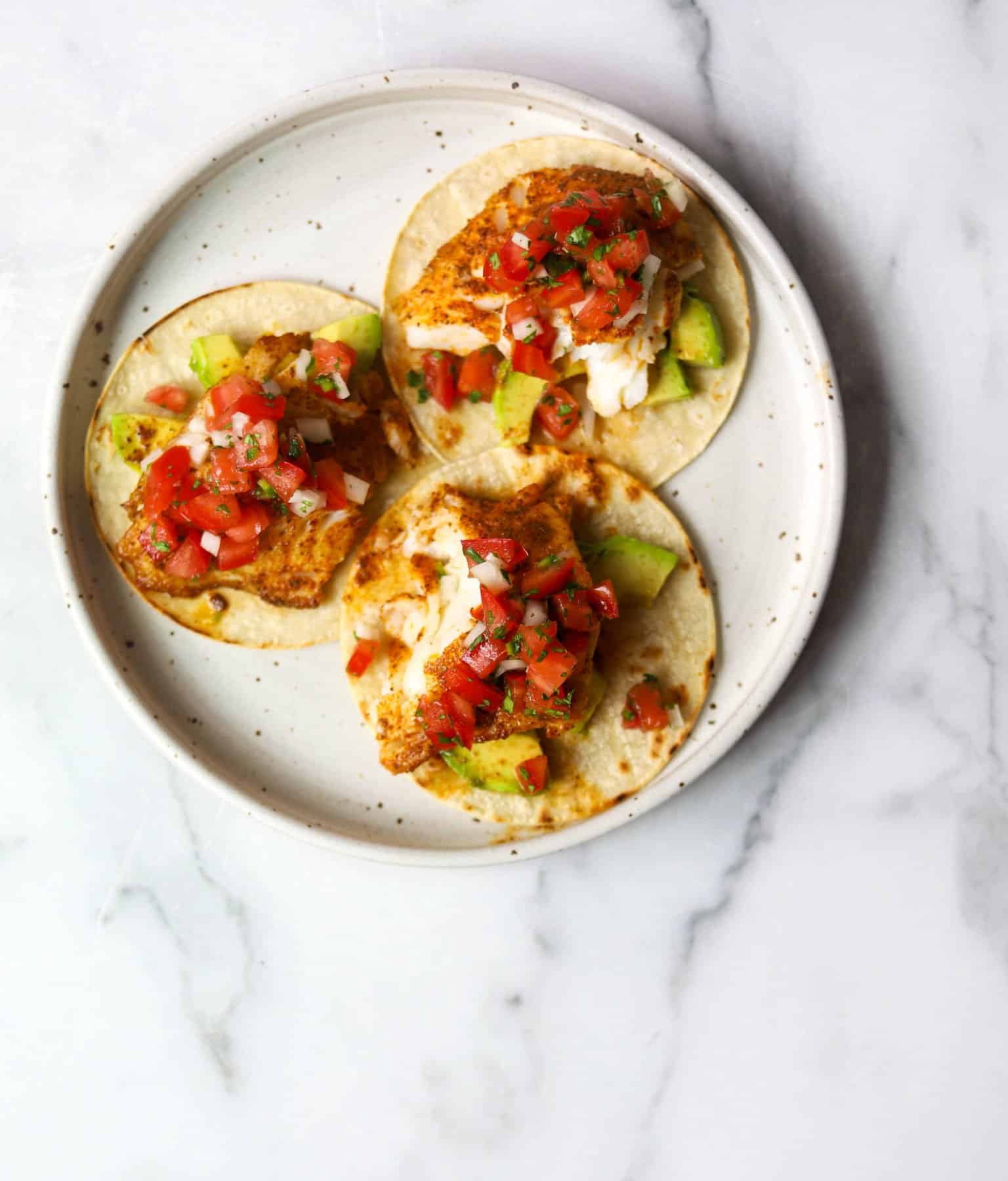 Fish tacos on a white plate