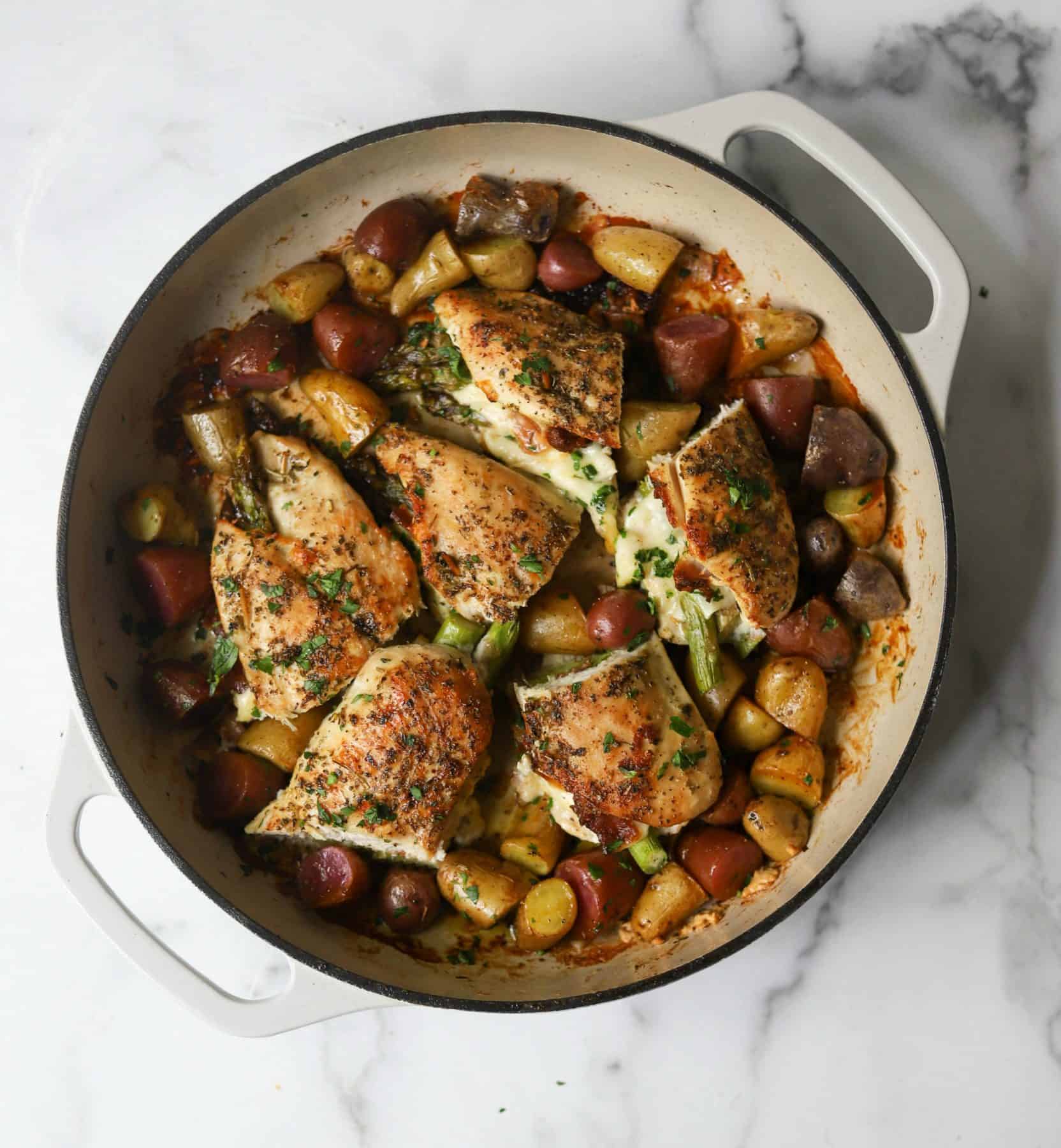 Asparagus stuffed chicken in a white pot