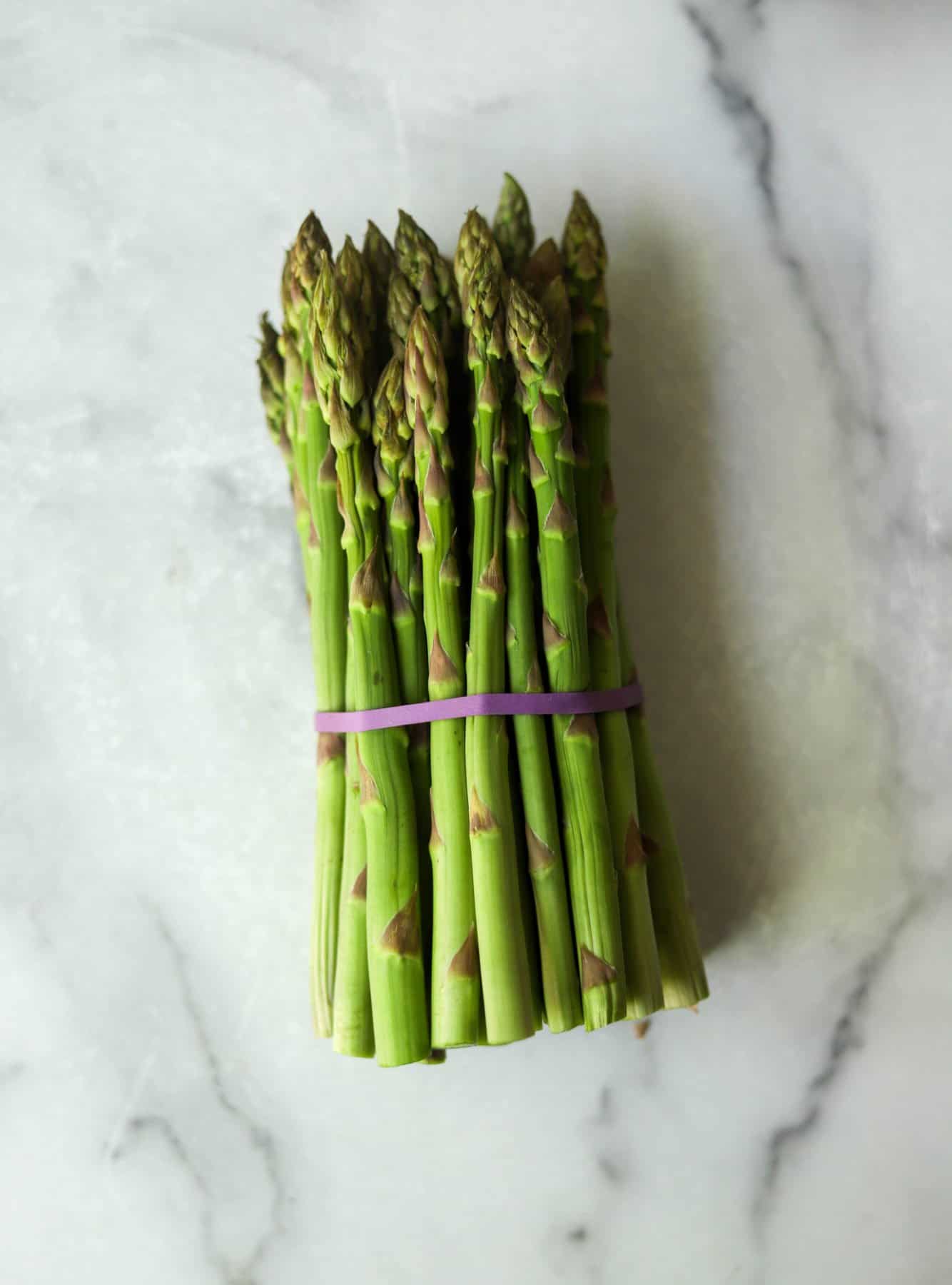 Asparagus spears on a marble backdrop