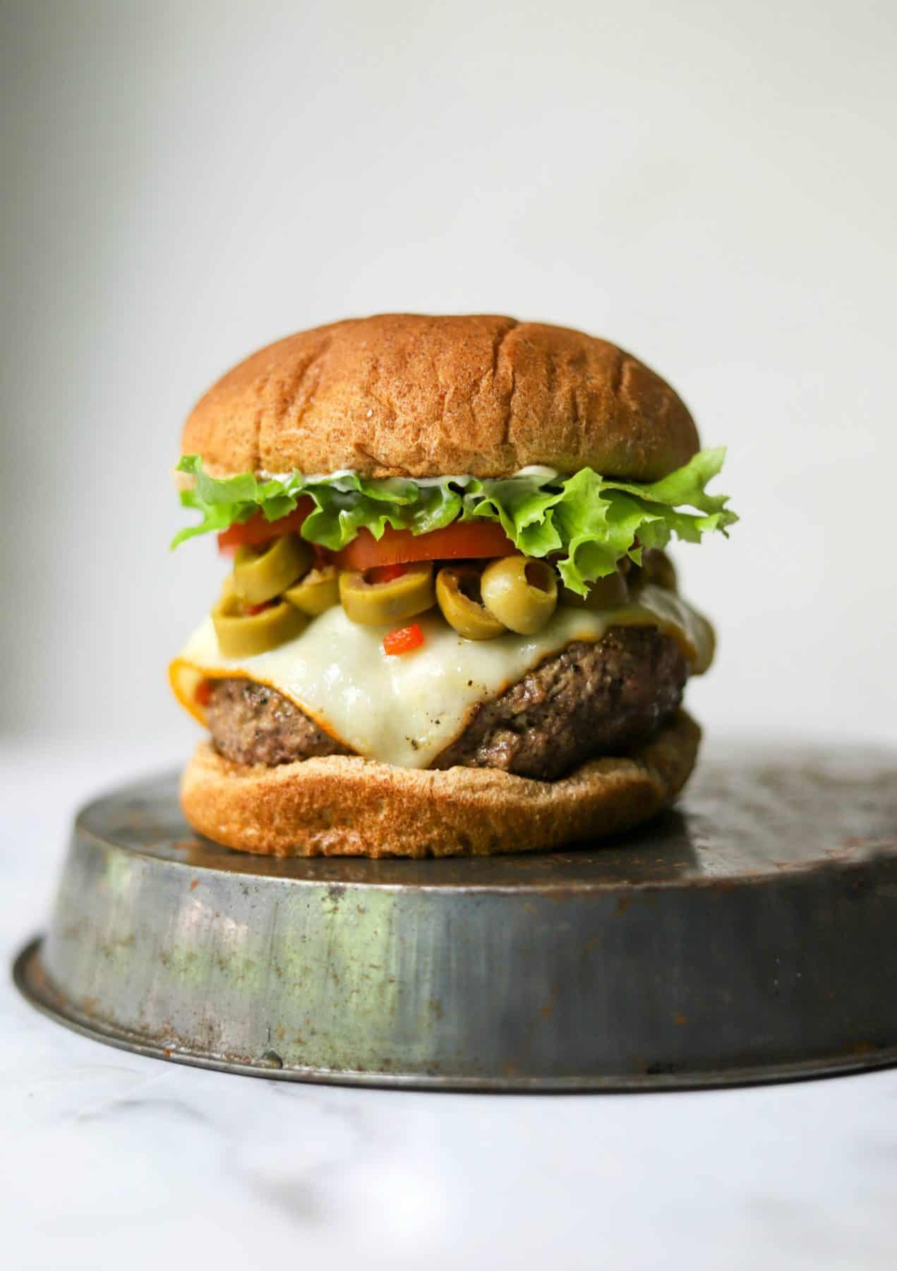 Cheesy olive burgers on a tin