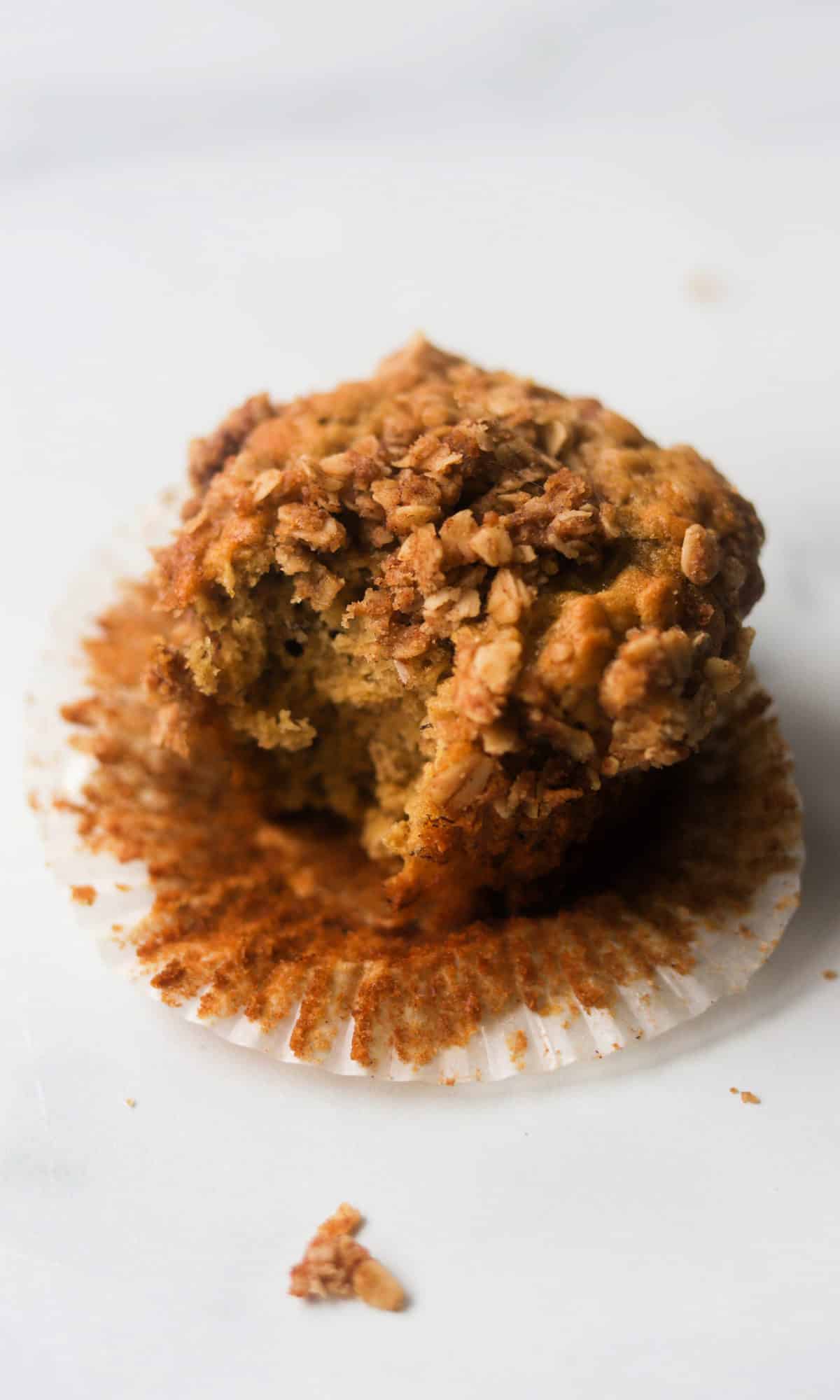 A side shot of a muffin with a bite taken out of it.