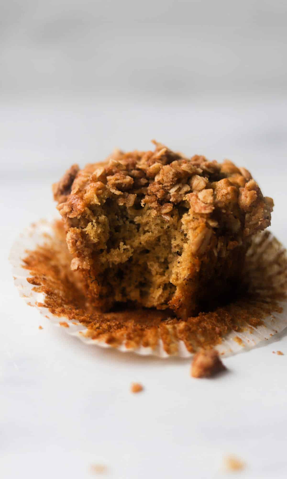 A side shot of a muffin with a bite taken out of it.