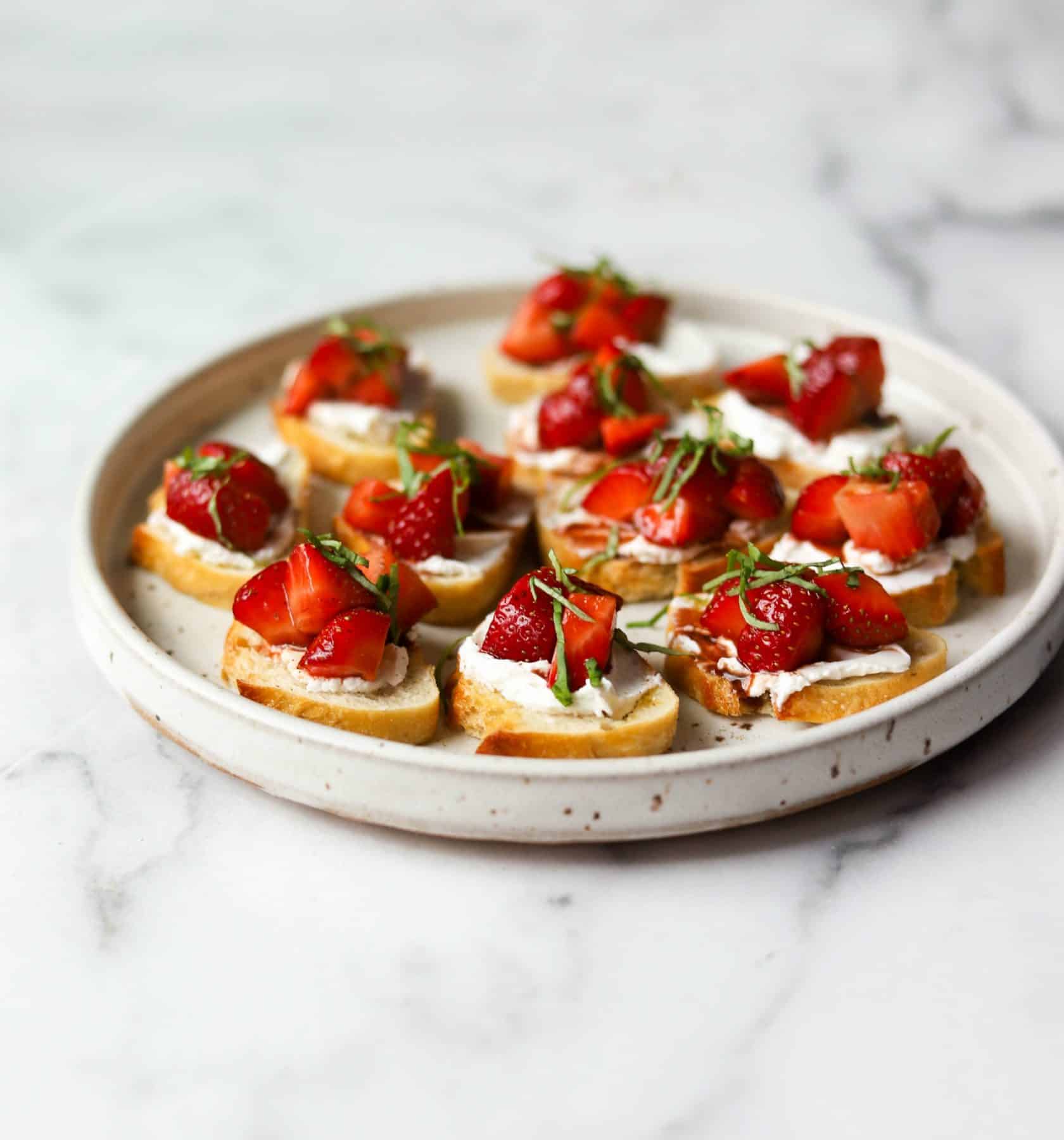 Strawberry basil bruschetta on a white plate