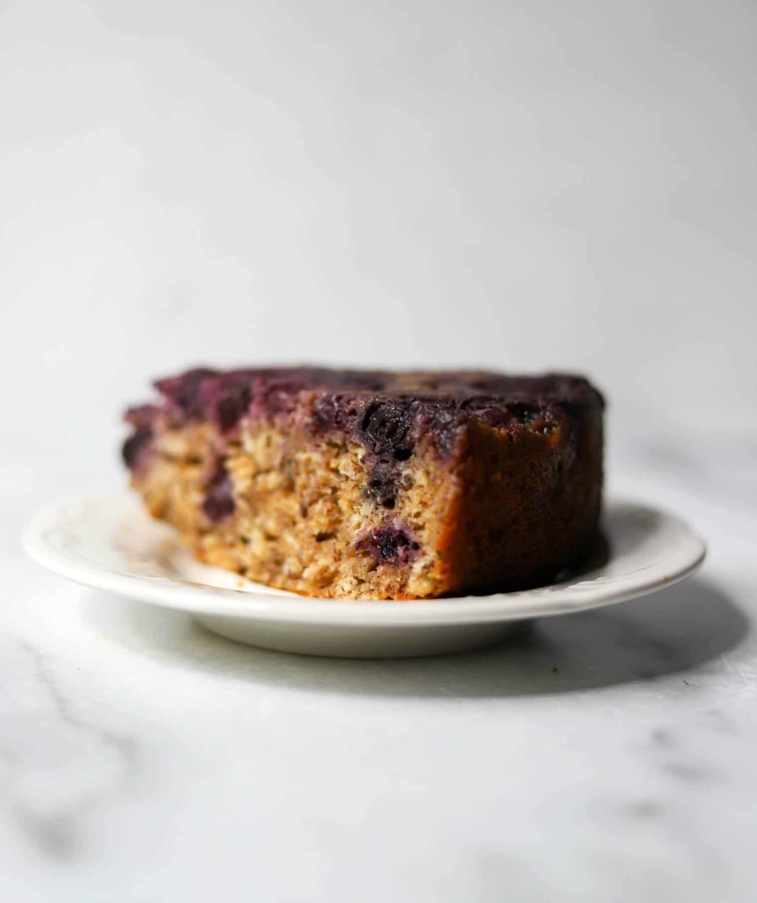 A slice of blueberry cake on a white plate