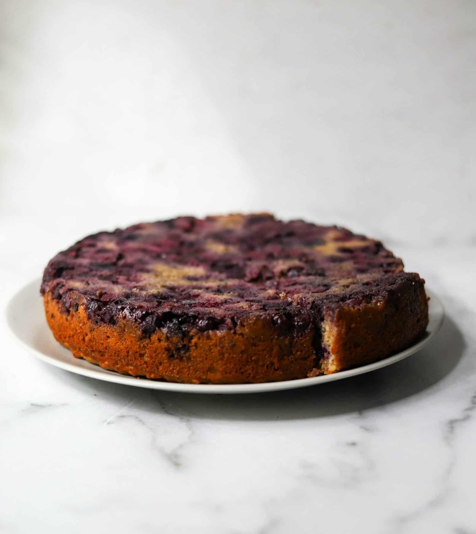 Blueberry upside down cake on a grey platter