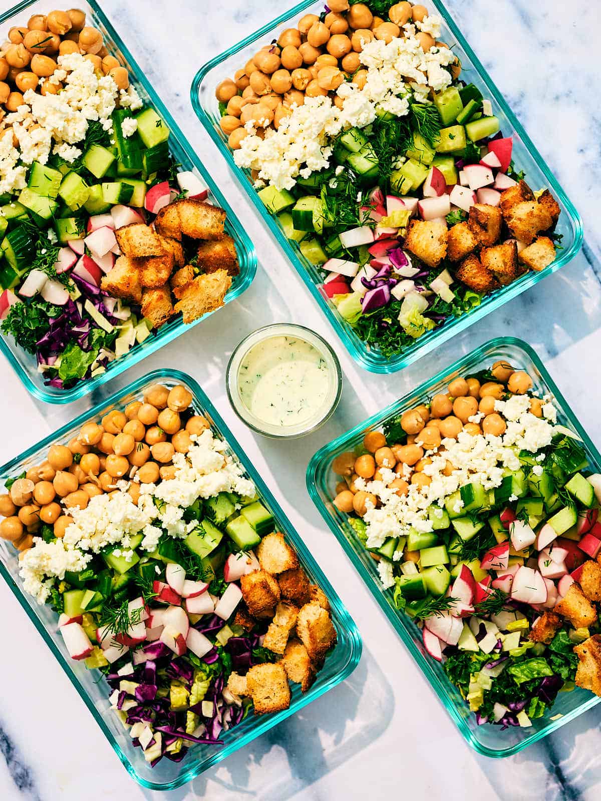 Meal prep dishes with Mediterranean chickpea salad.