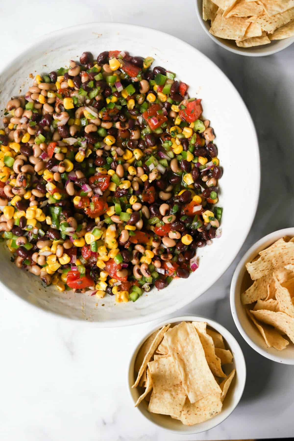 Cowboy caviar in a white bowl with tortilla chips