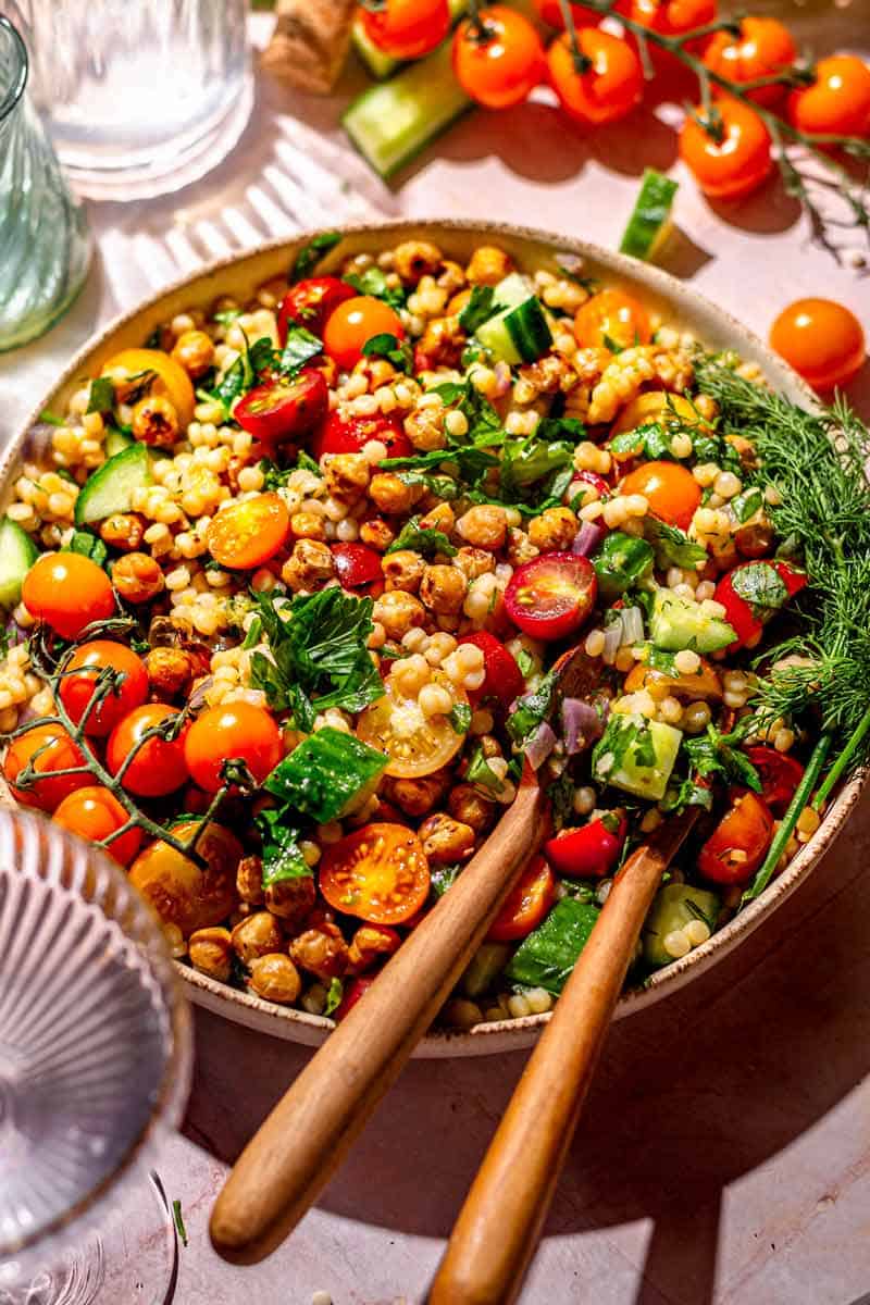 A close up shot of a bowl of couscous vegetable salad.