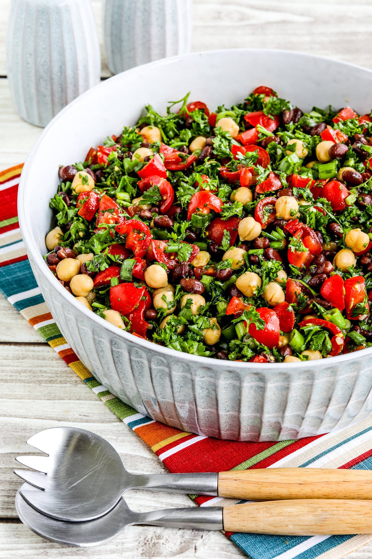 A side shot of a bowl of bean herb salad.