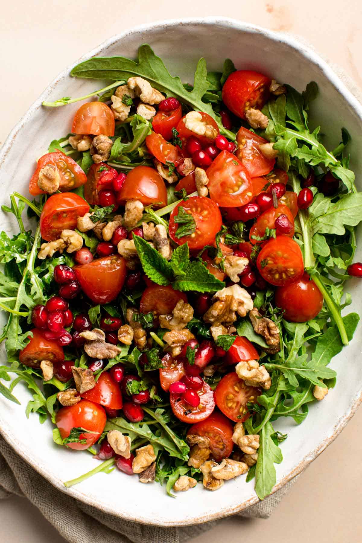 An overhead shot of a dish of arugula salad.
