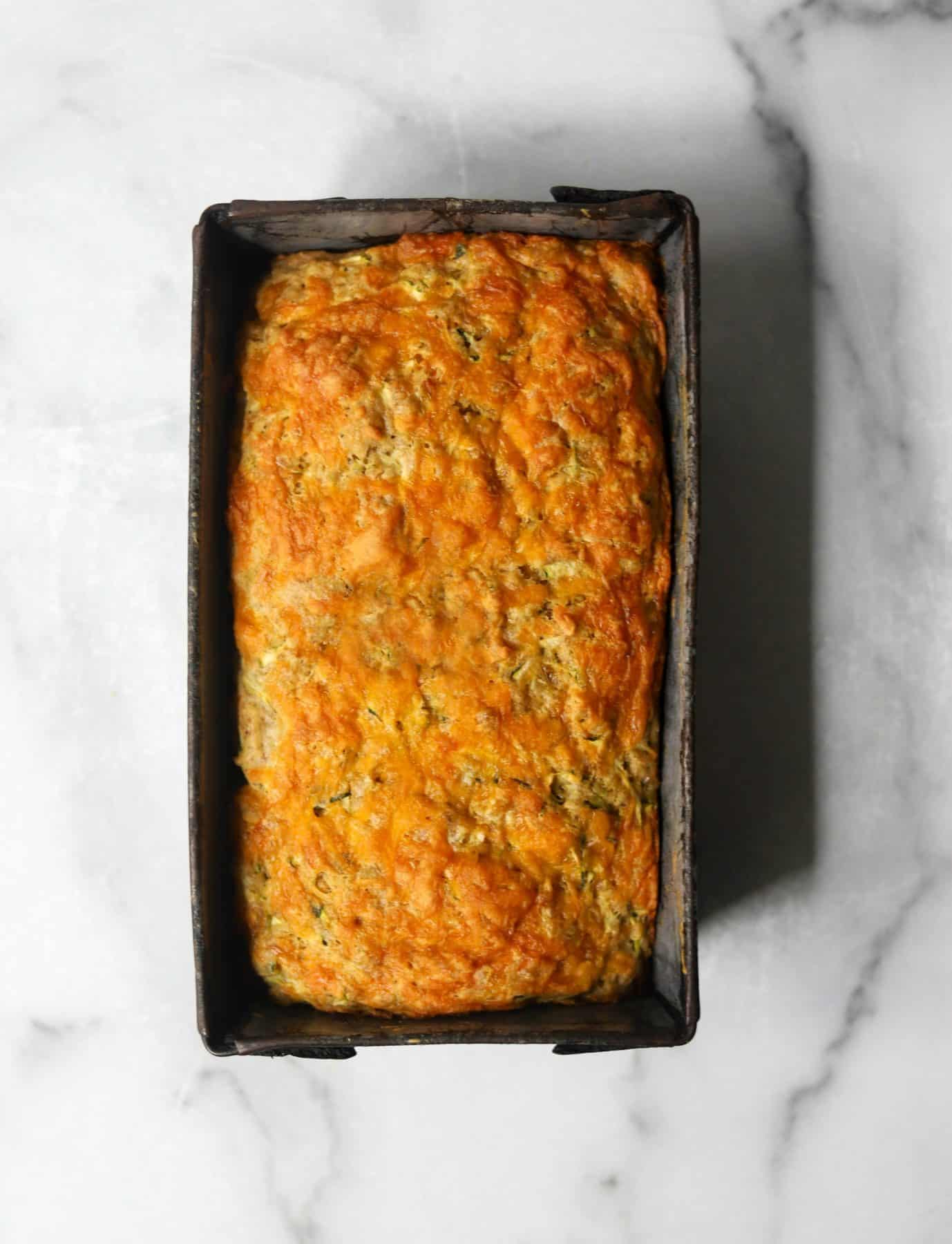 Cheesy zucchini bread in a tin