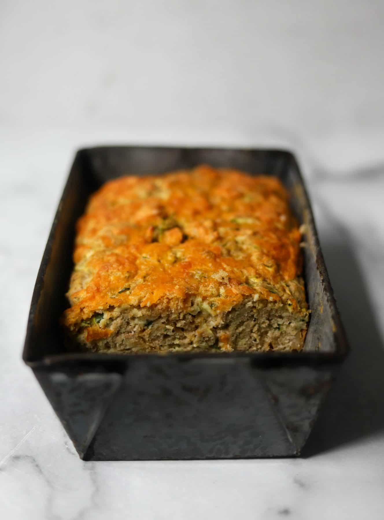 Cheesy zucchini bread in a tin