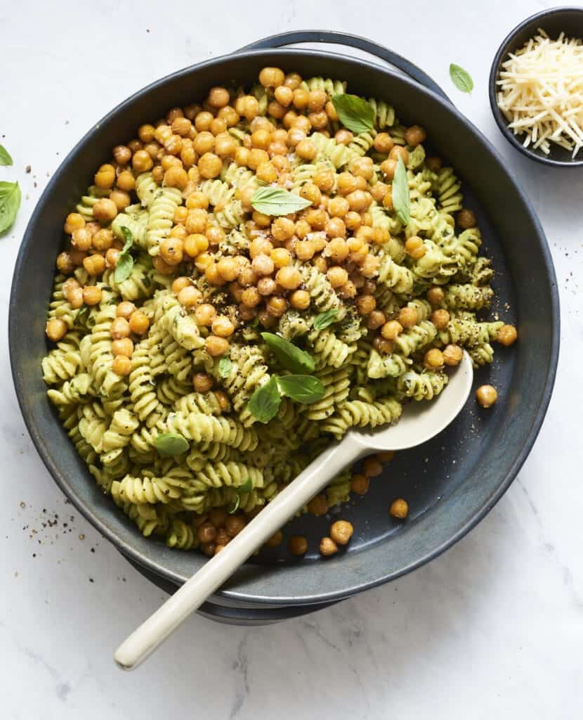 An overhead shot of a bowl of avocado pasta with chickpeas.