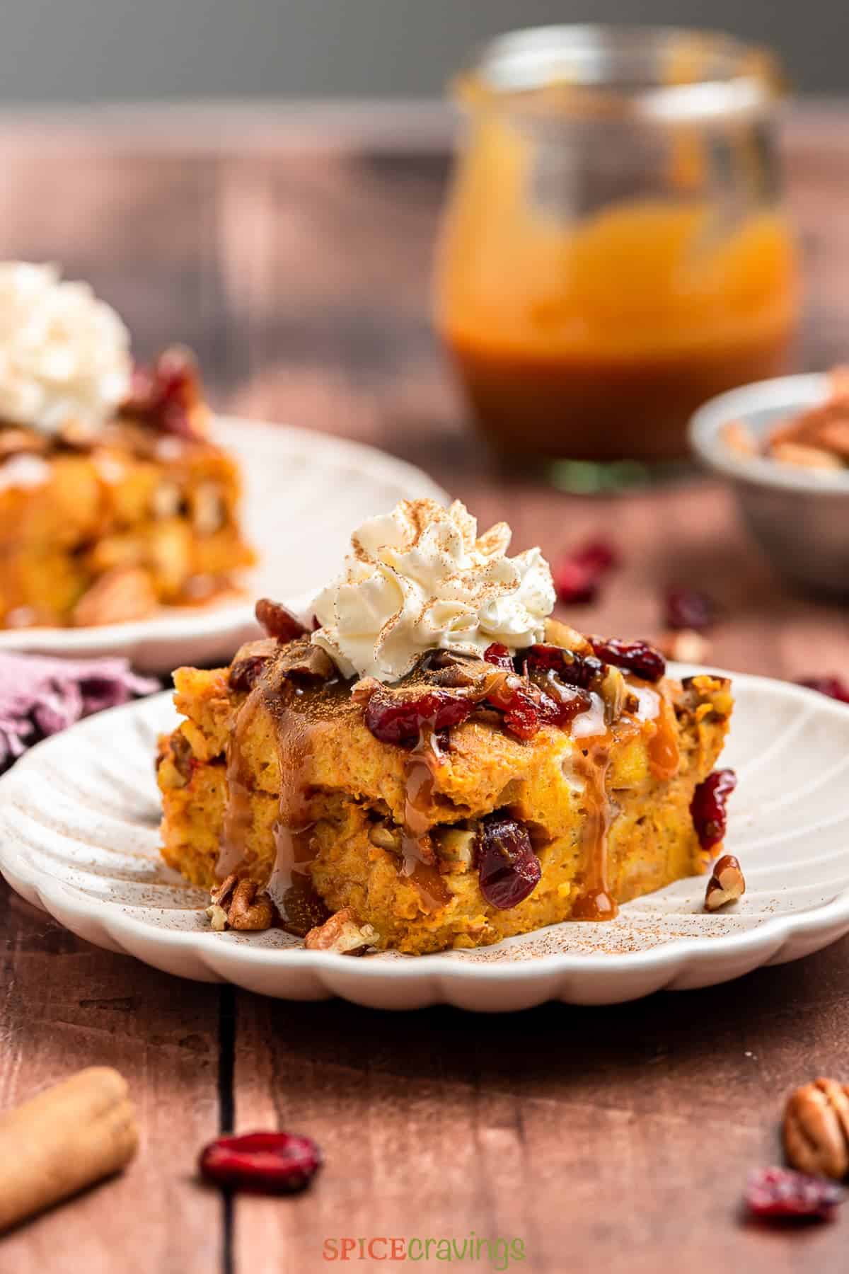 A front shot of a slice of pumpkin bread pudding on a plate.