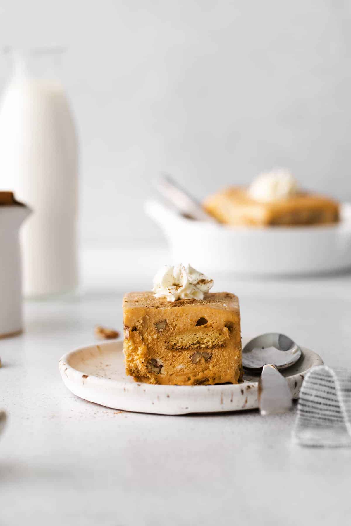 A front shot of a slice of pumpkin ice box pie.