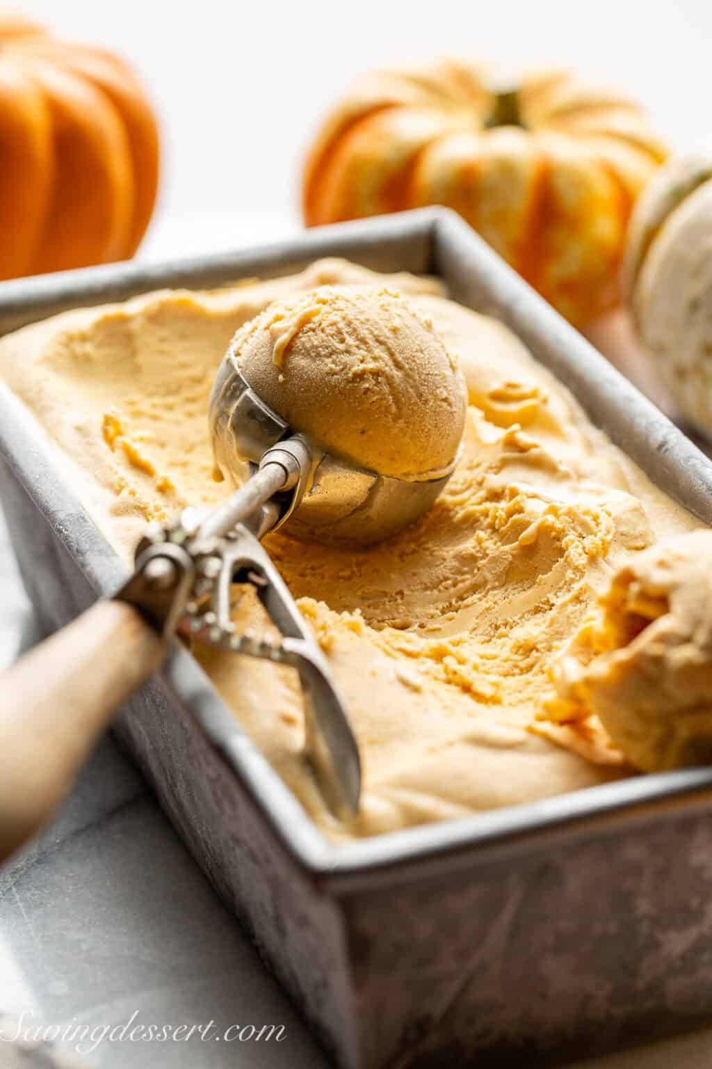 A front shot of pumpkin gelato scoop in a bread pan.
