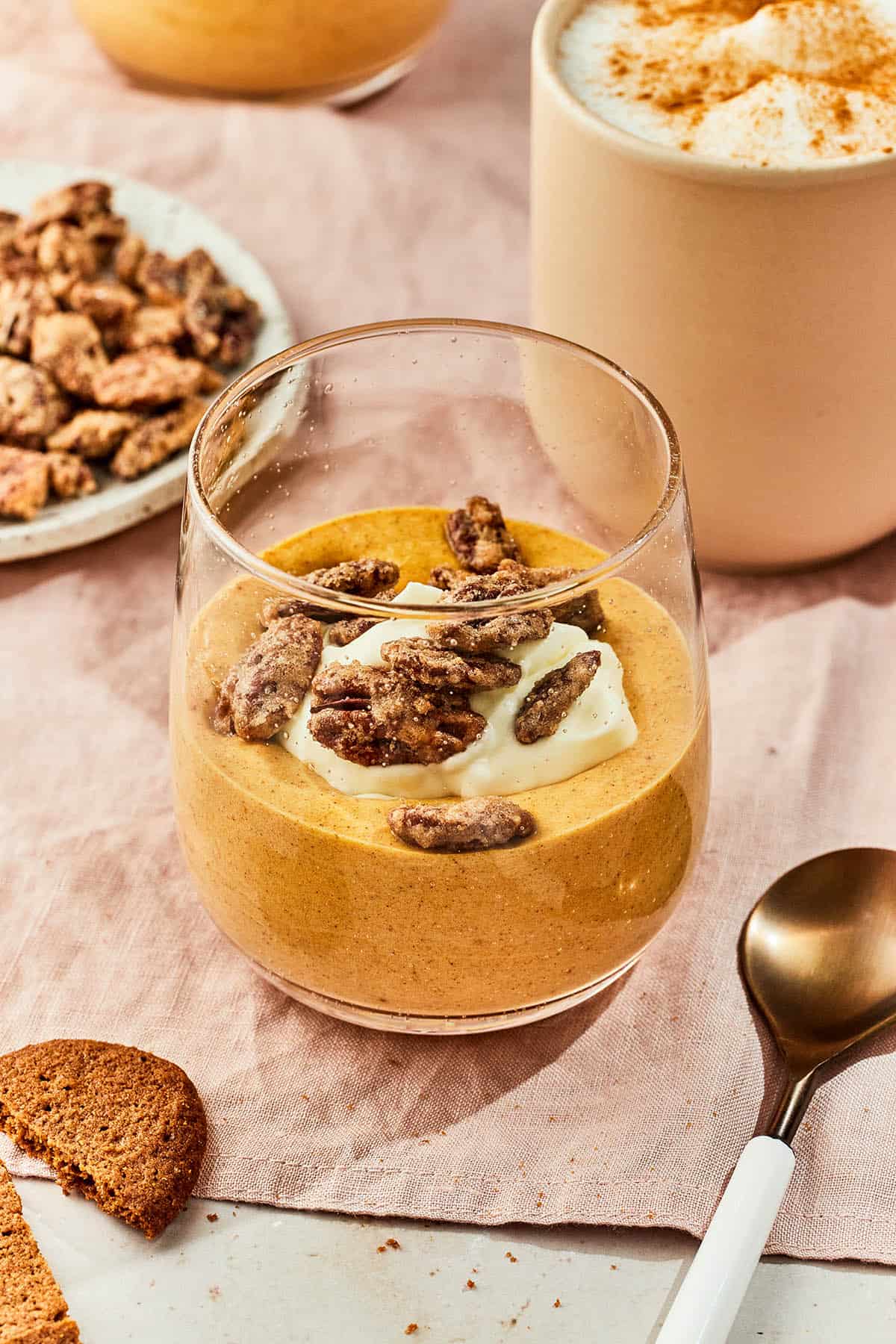 A front angled shot of pumpkin mousse in a glass.