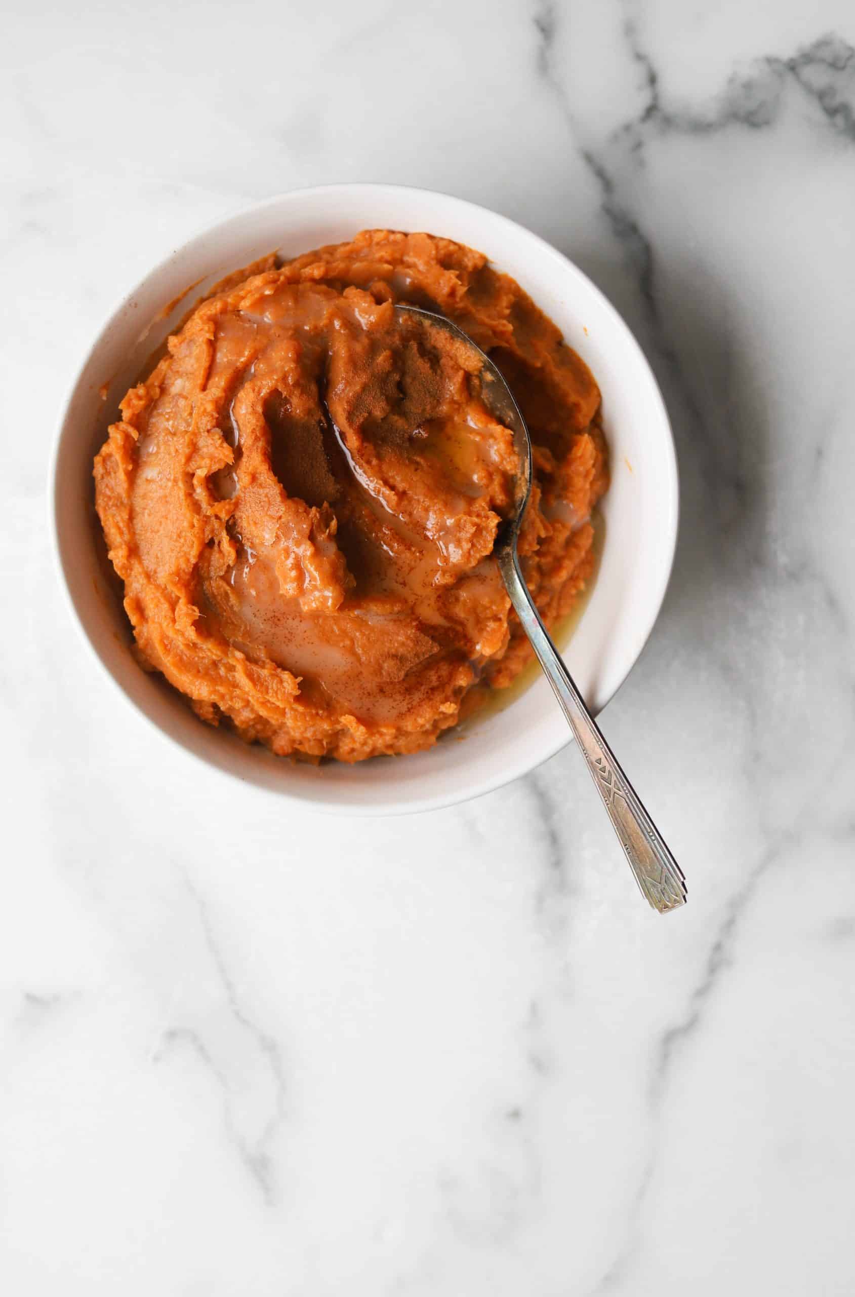 Maple mashed sweet potatoes in a white bowl