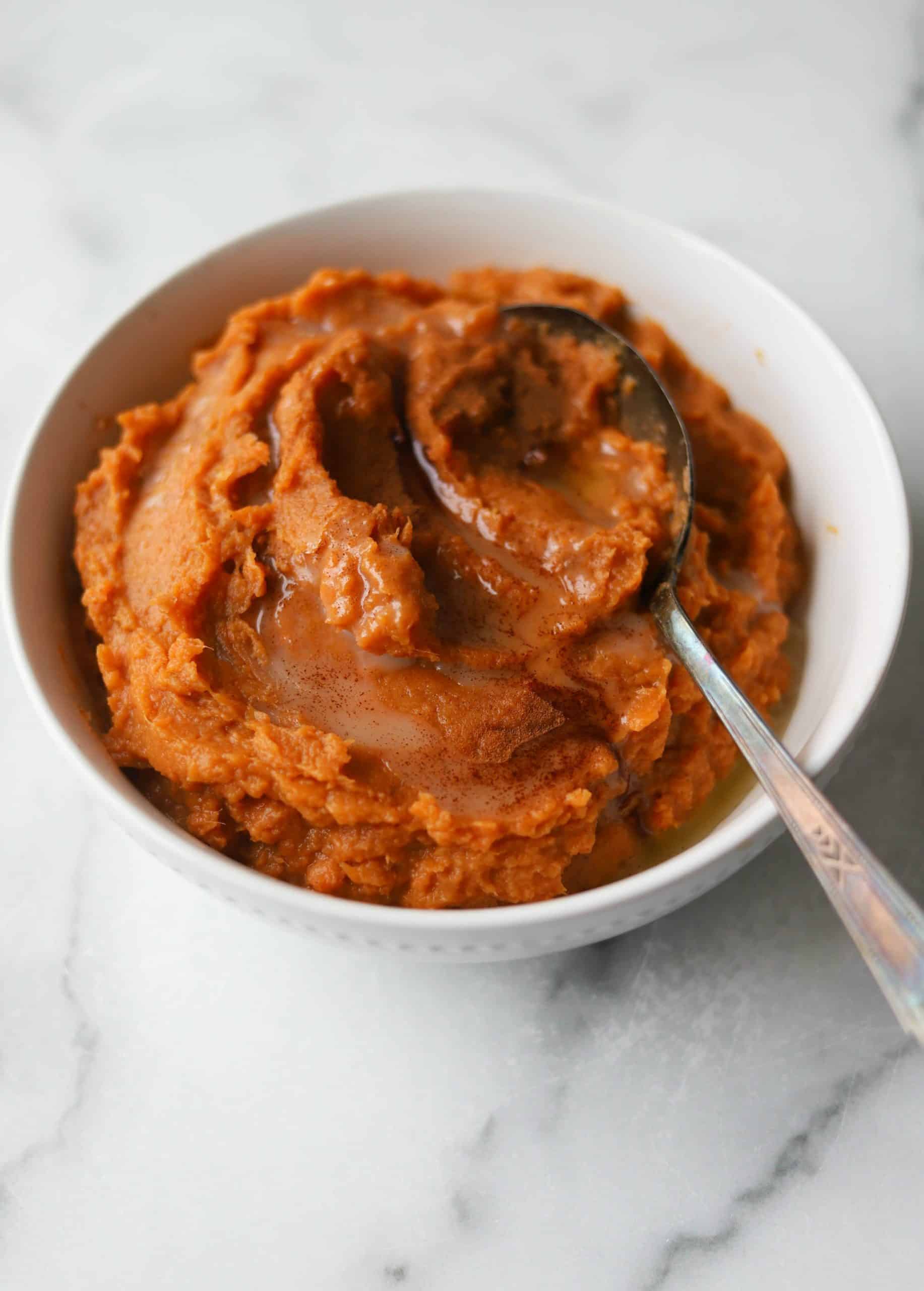 Maple mashed sweet potatoes in a white bowl