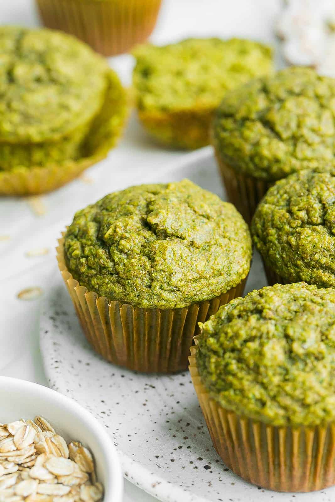 A front shot of green spinach banana muffins.