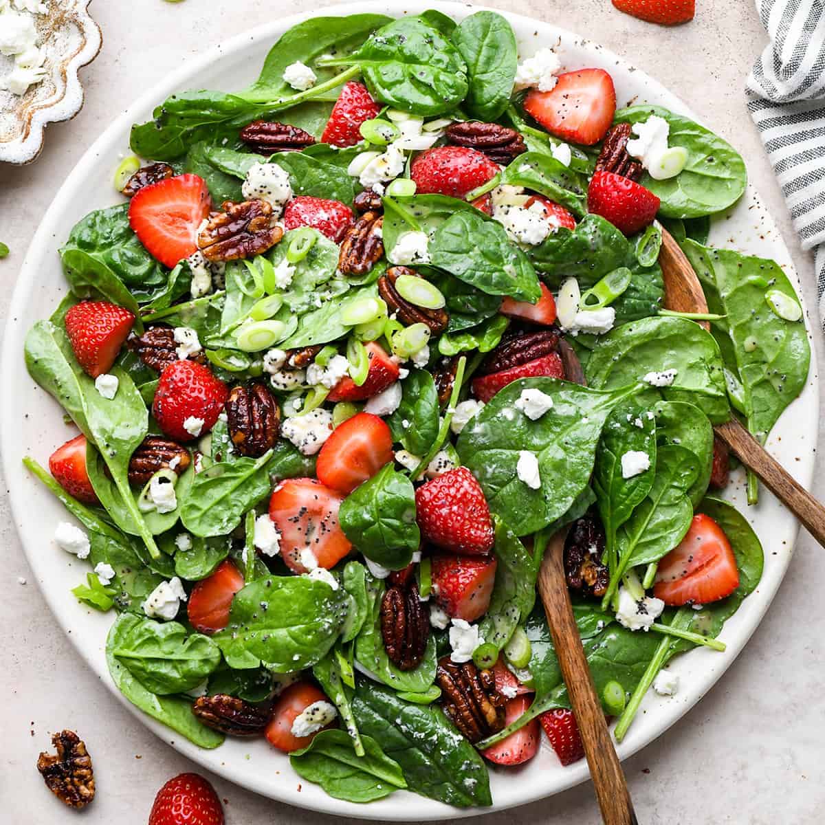 An overhead shot of a bowl of strawberry spinach salad.