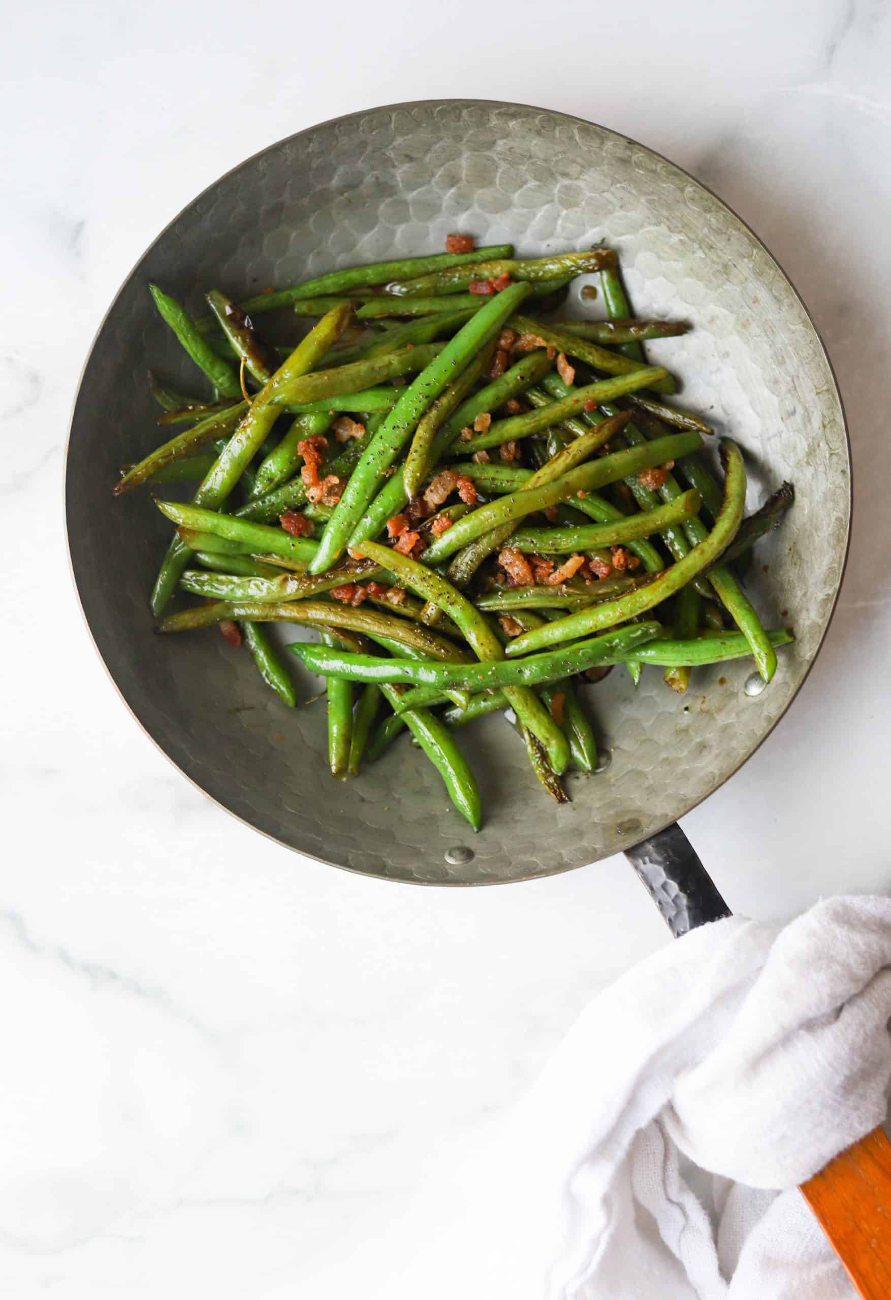 Green beans in a copper pan.