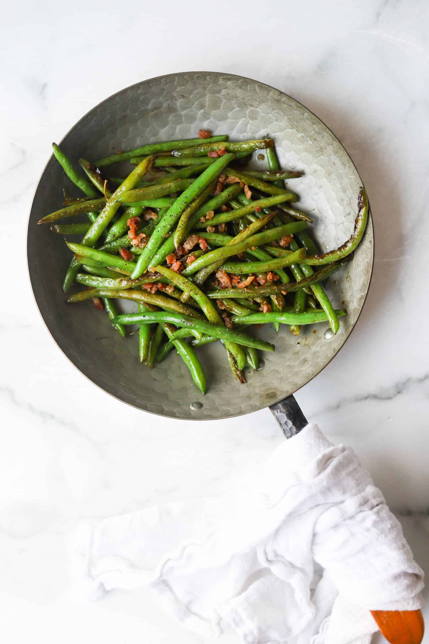 Green beans in a copper pan.