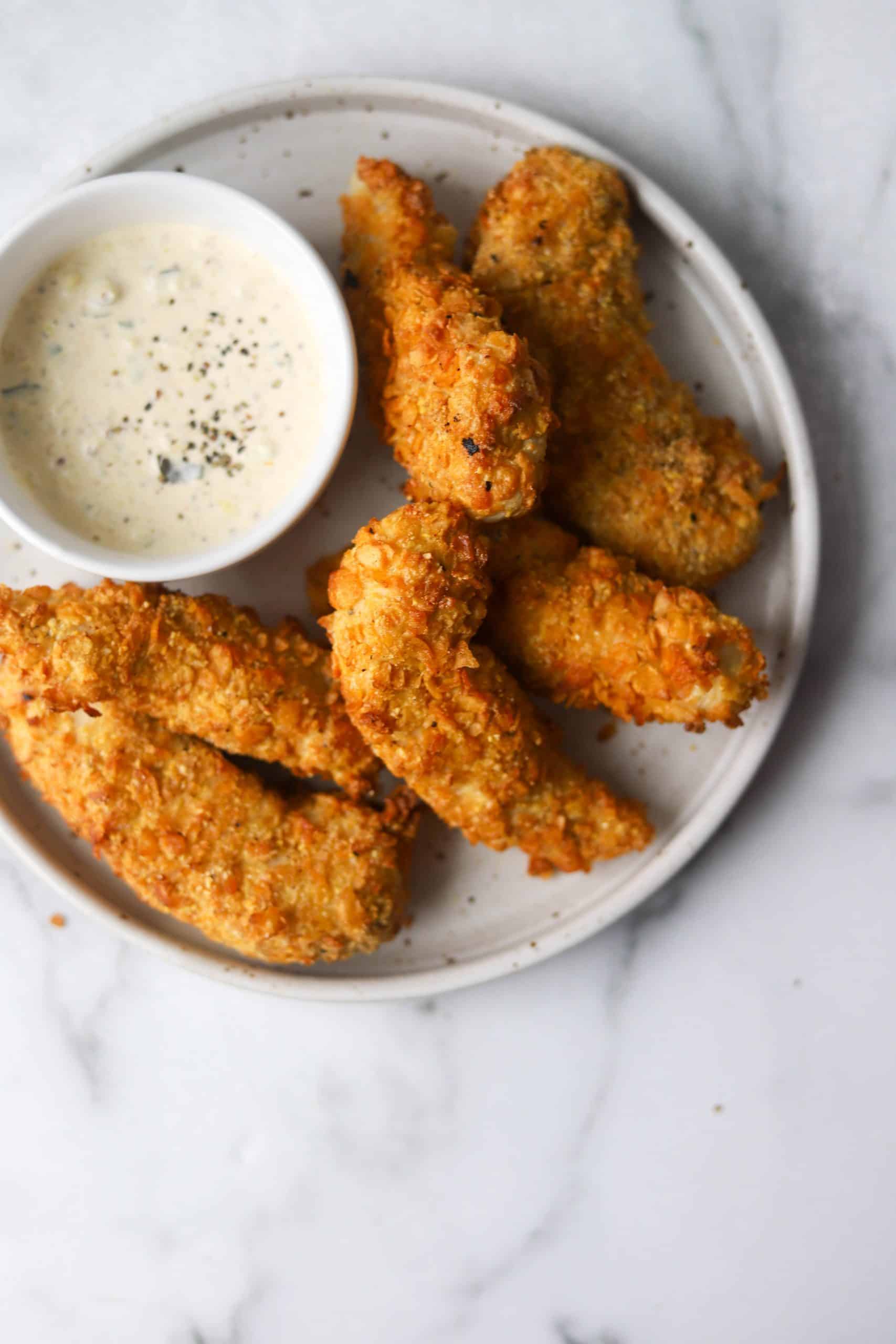 Chicken tenders on a plate with dipping sauce