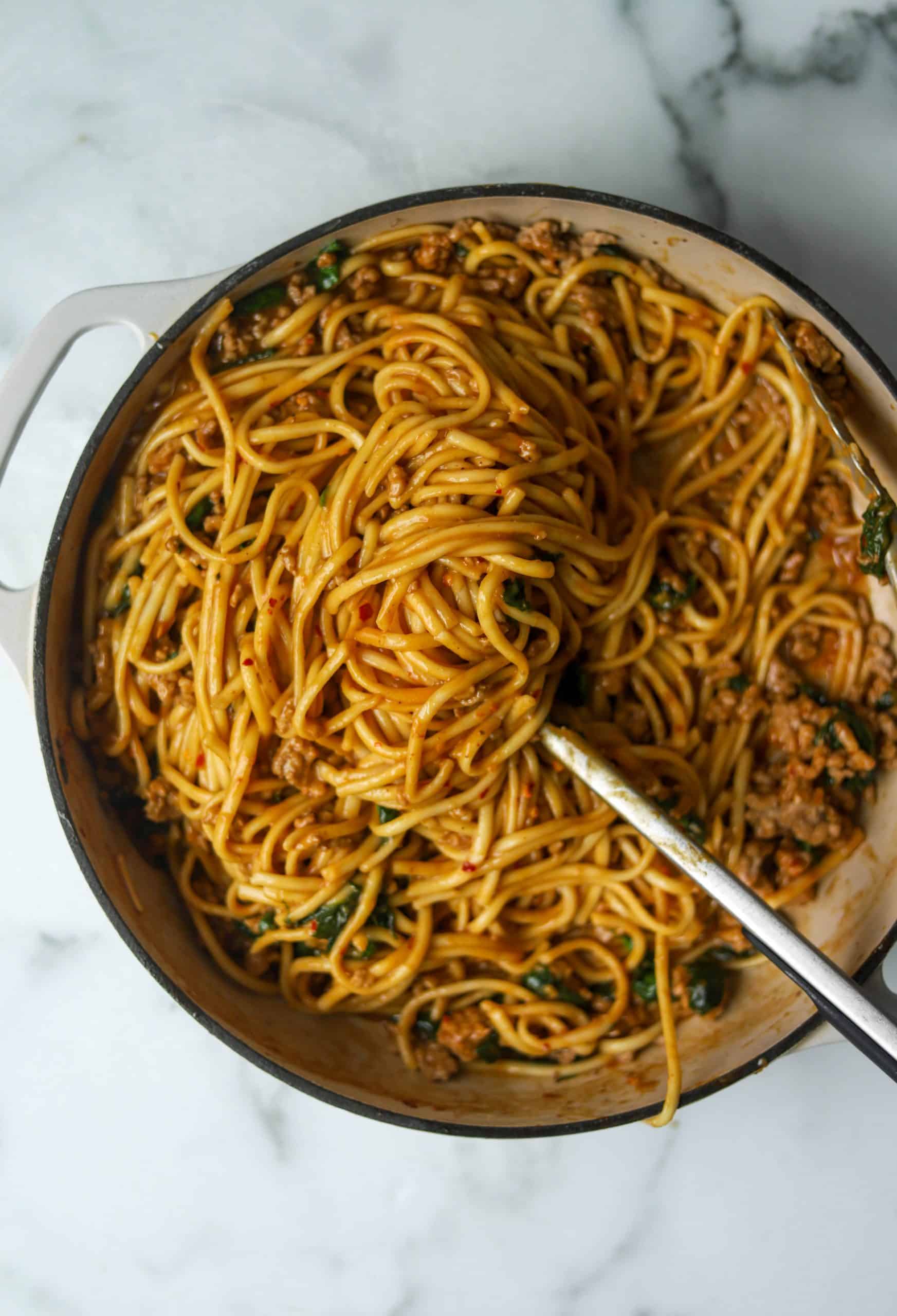 Spicy dan dan noodles in a white pan