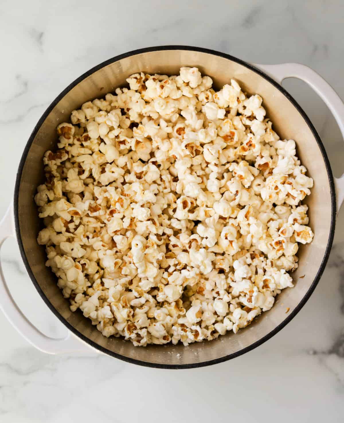 An overhead shot of a pot of stovetop popcorn.