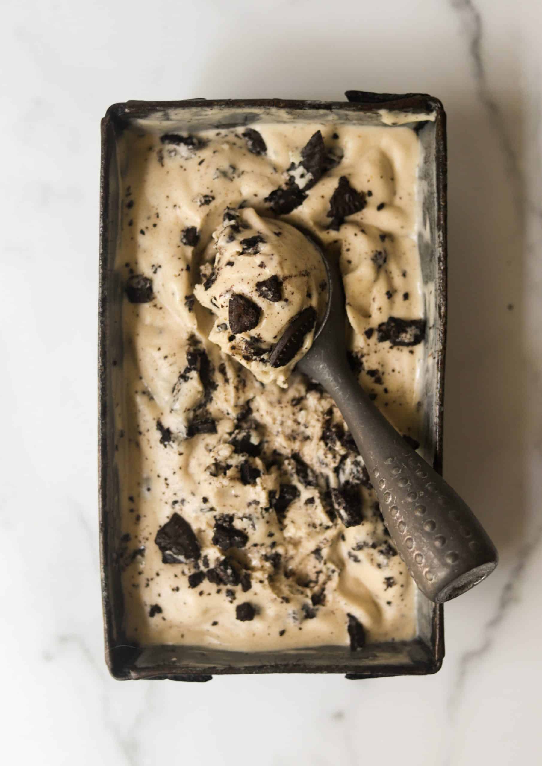 A vintage loaf pan filled with cookies and cream nice cream.