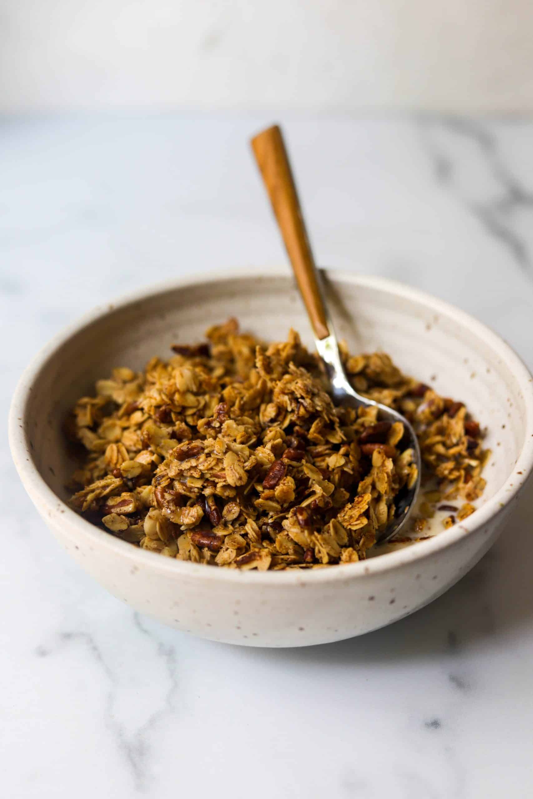 A side shot of a bowl of honey nut granola.