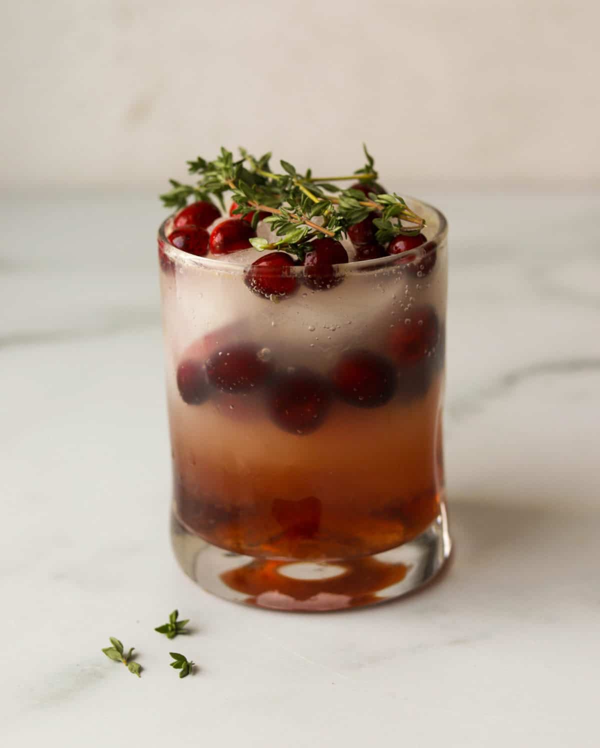 A front shot of a glass of cranberry orange mocktail.