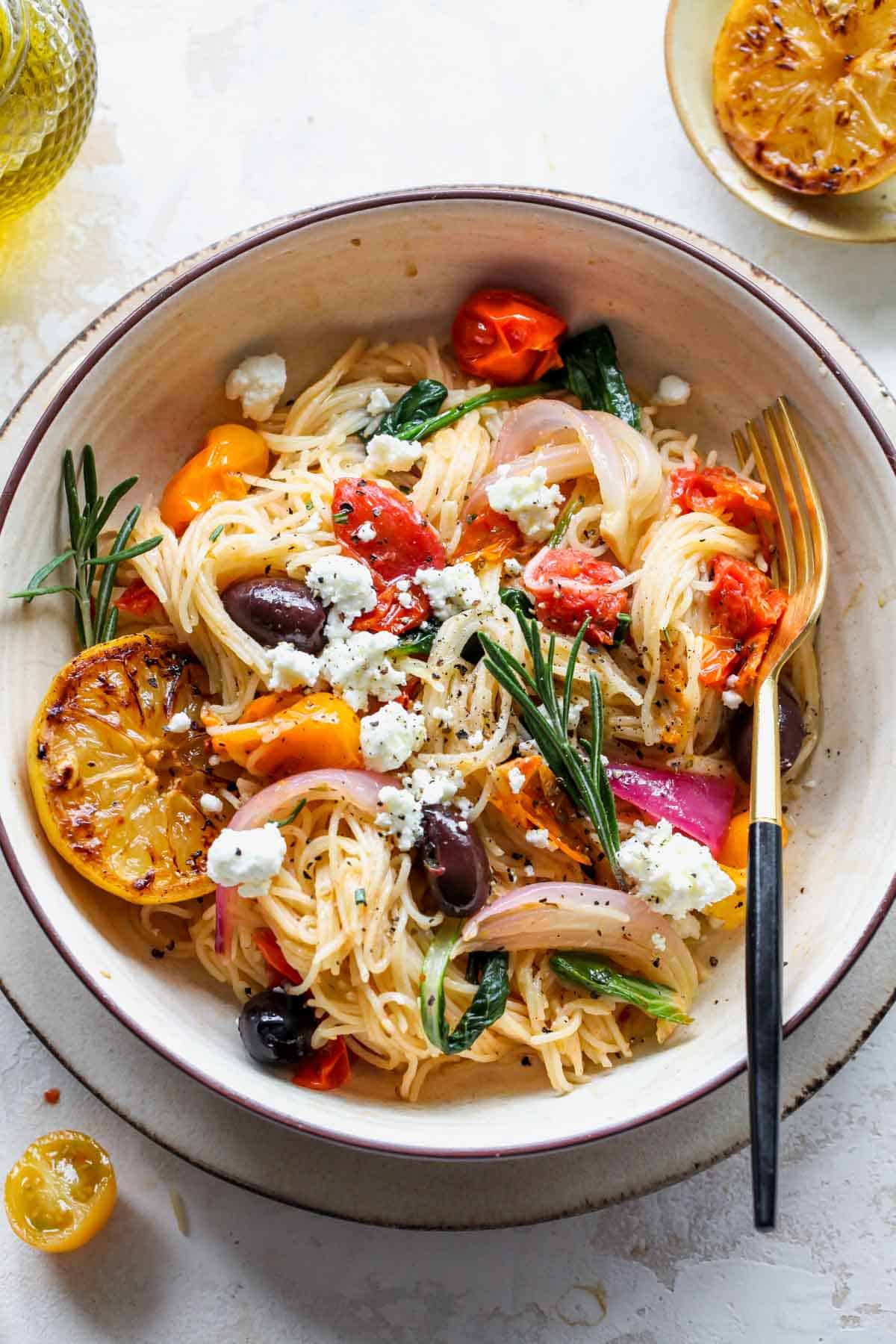 An overhead shot of a dish of Mediterranean veggie pasta.