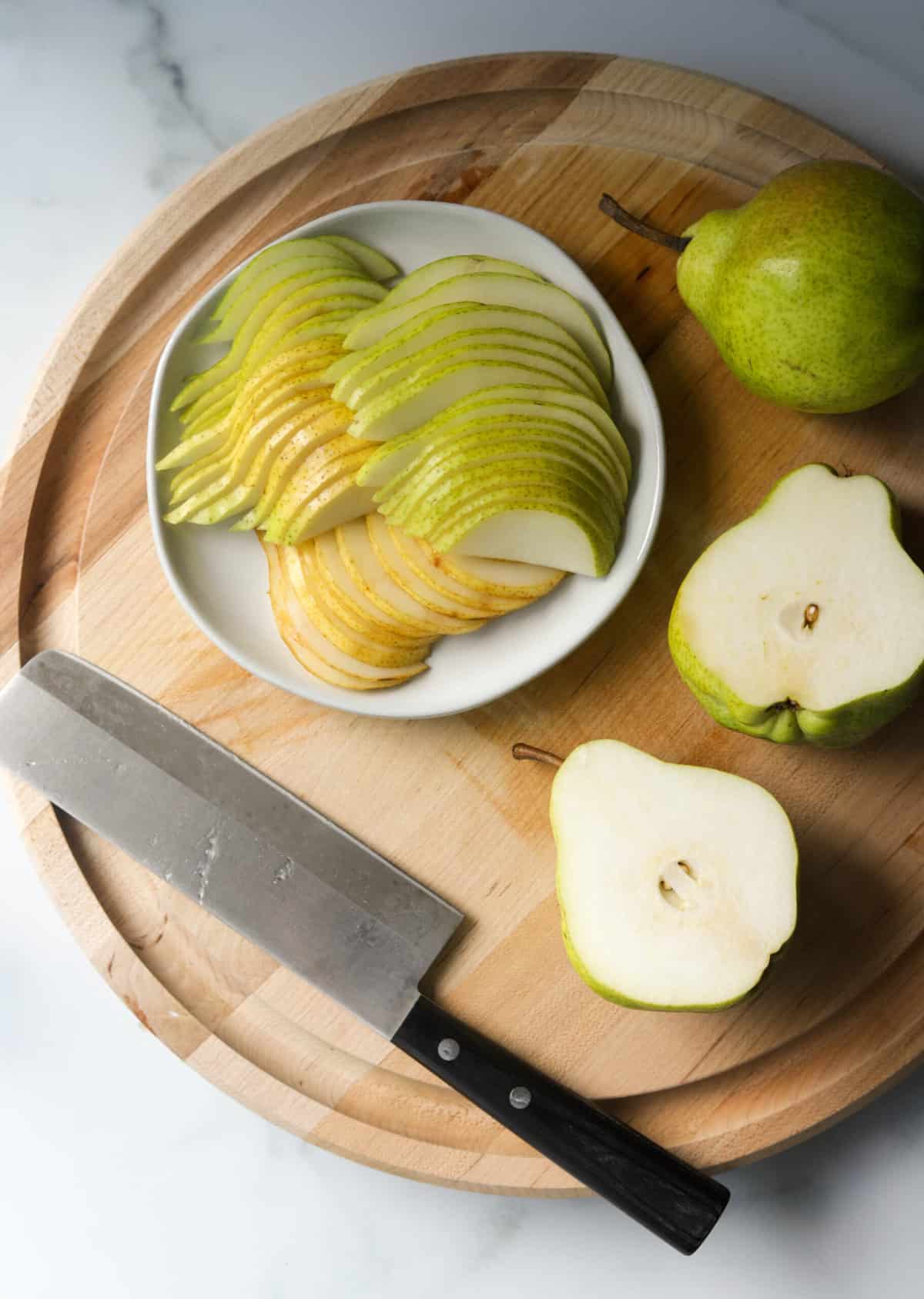 An overhead shot of sliced pears on a cutting board.