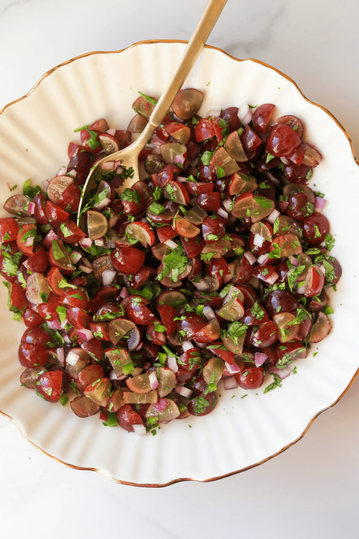 An overhead shot of a bowl of grape salsa.
