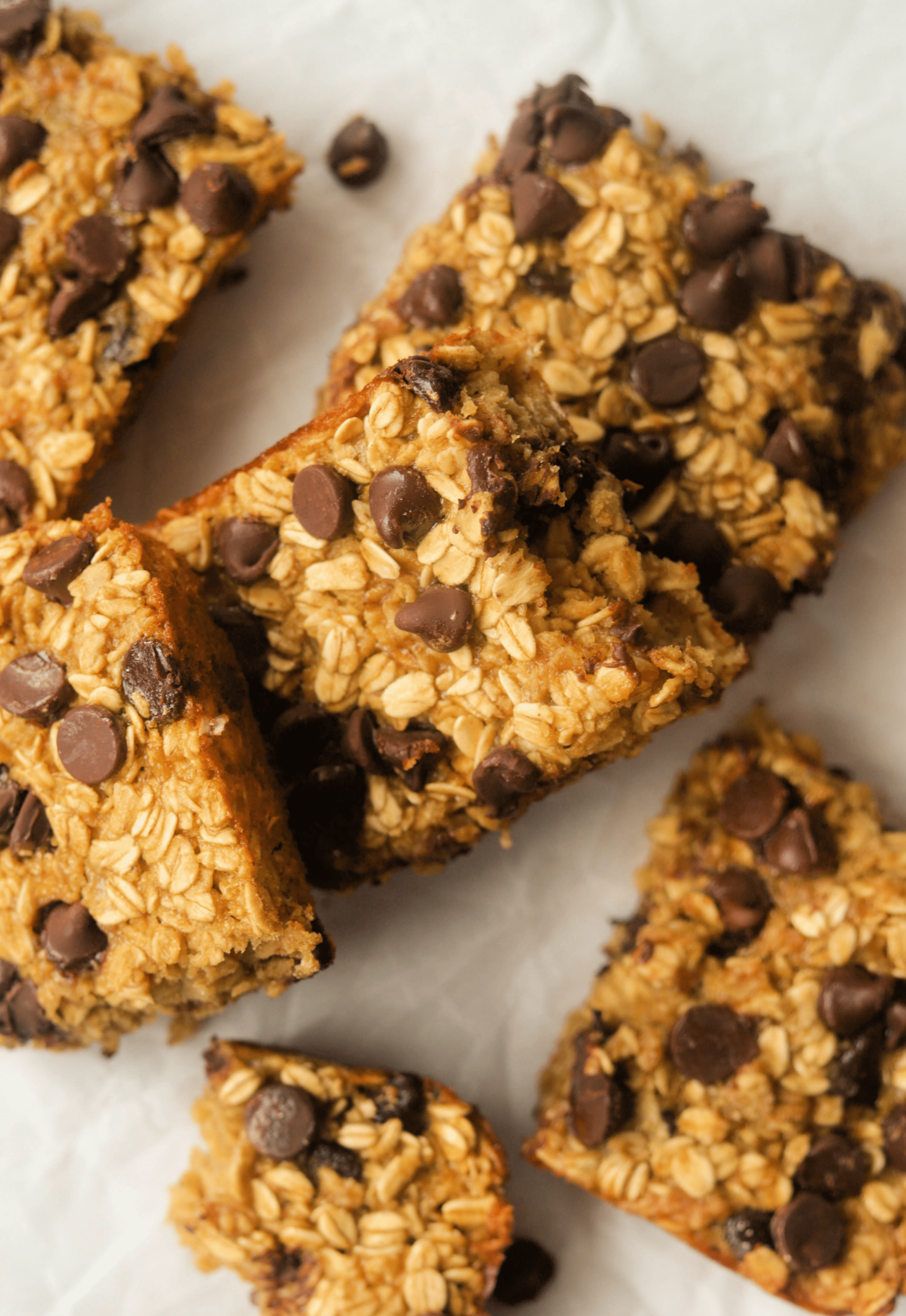 An overhead shot of squares of chocolate chip baked oats.
