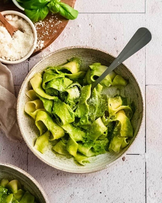 An overhead shot of a bowl of spinach pasta.