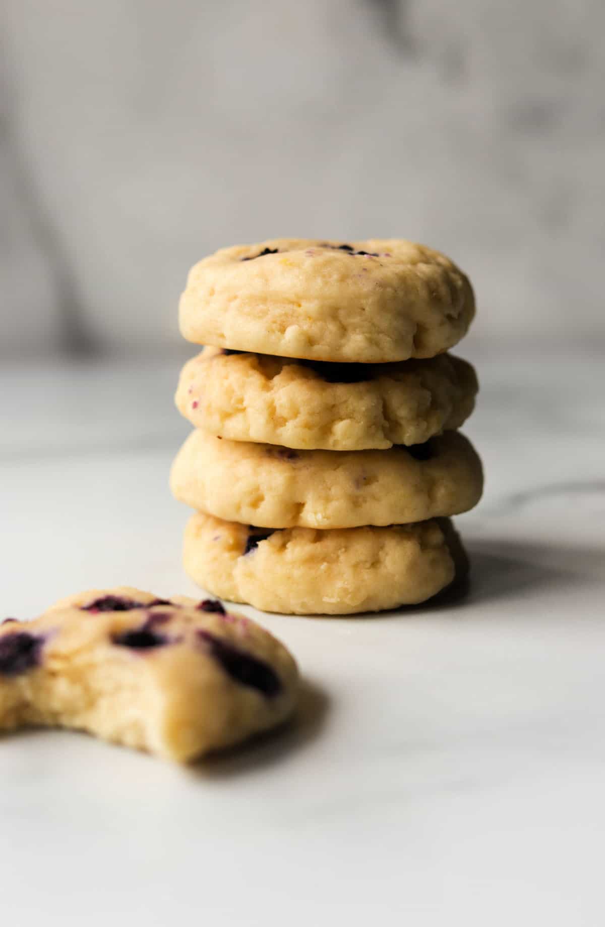 A front shot of a stack of lemon blueberry cookies.