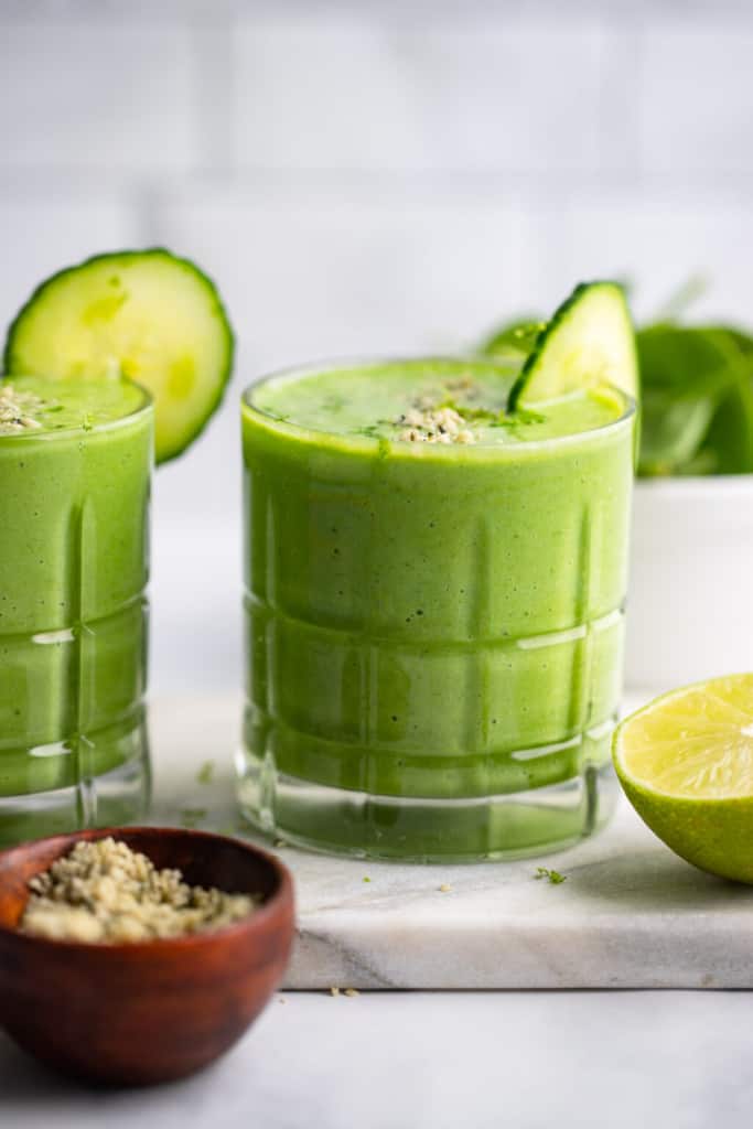 A front shot of a glass of a pineapple spinach smoothie.