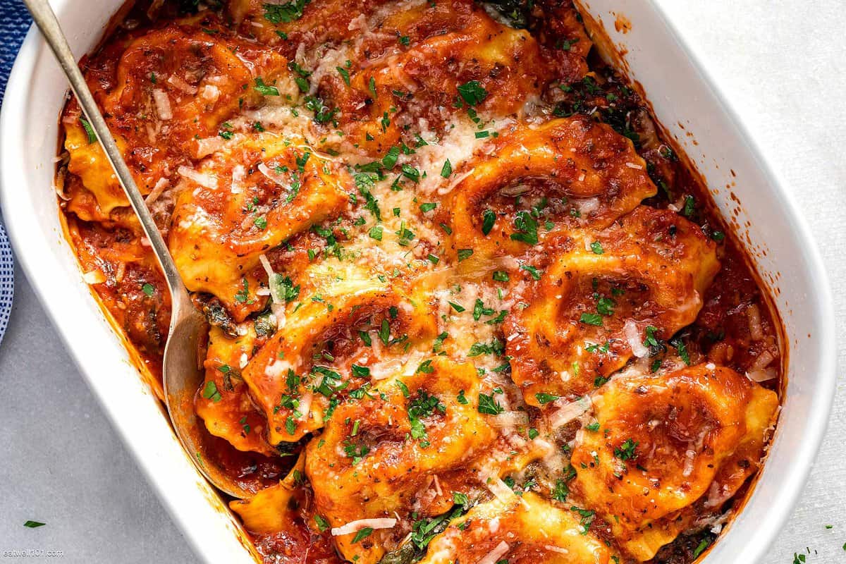 An overhead shot of a pan of spinach ravioli.