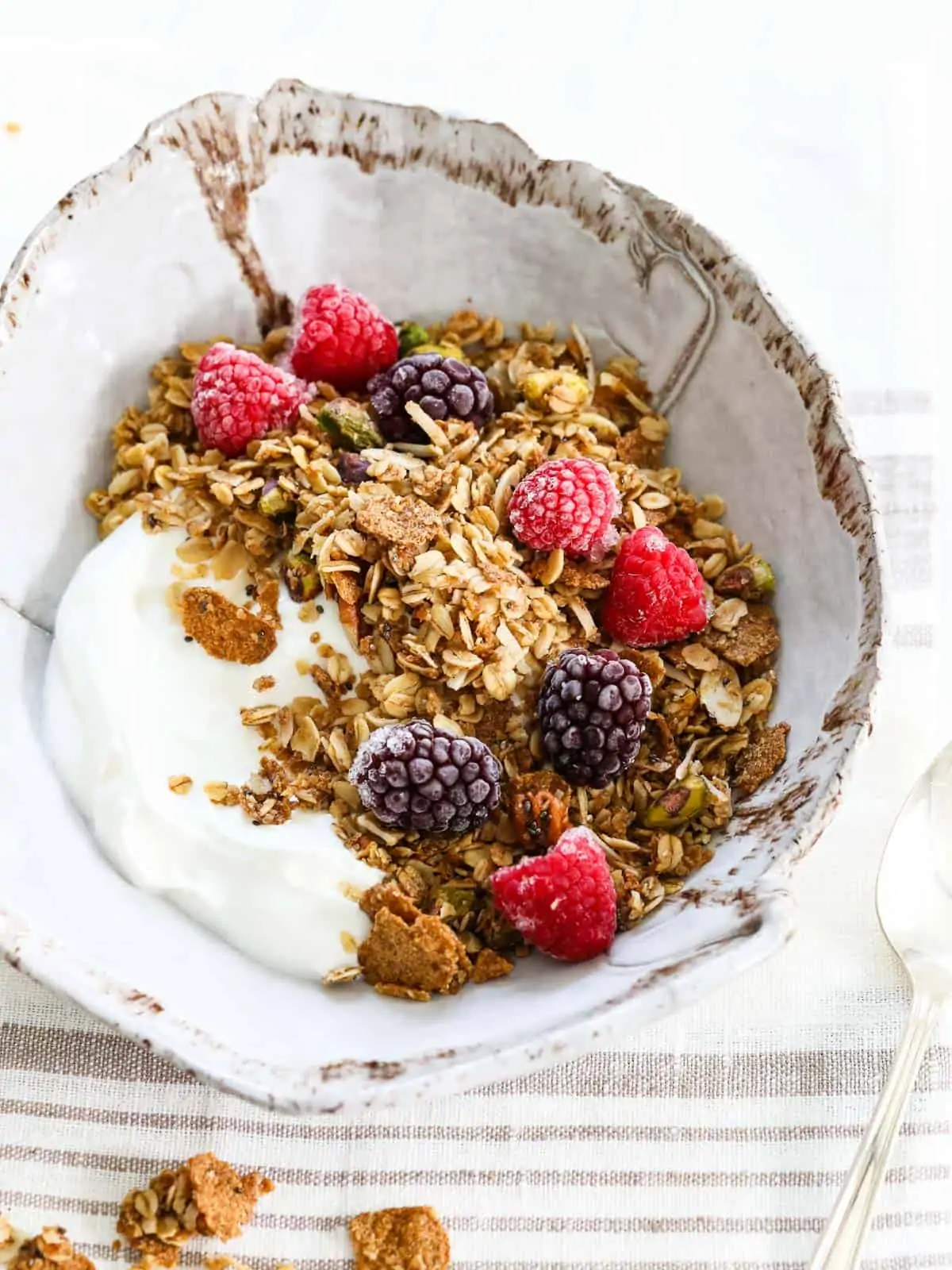 An overhead shot of granola with yogurt and berries.